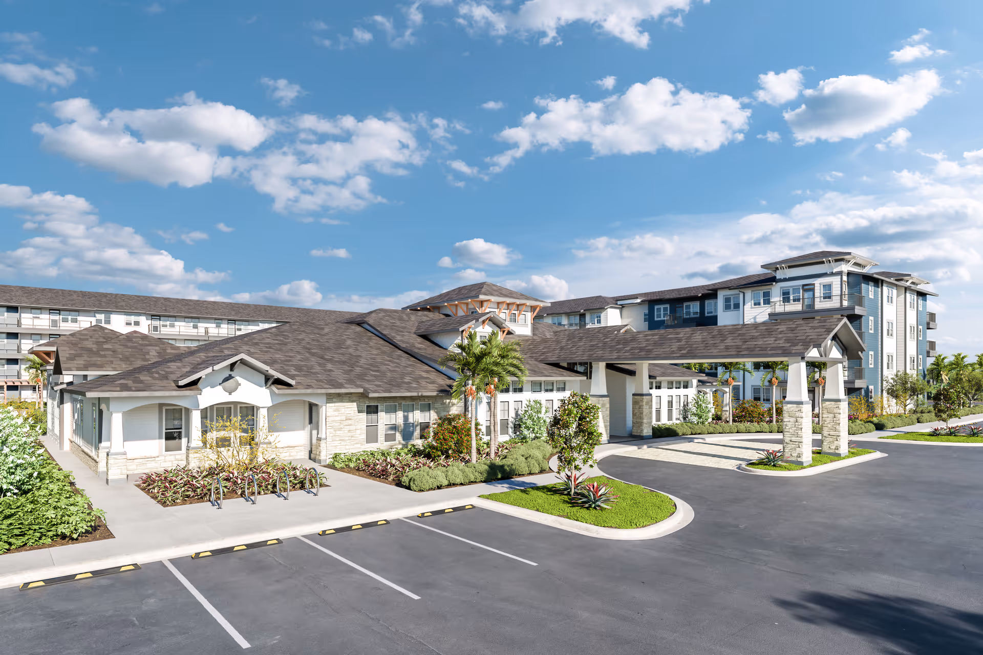 Modern senior living facility exterior with entry canopy, parking, and landscaped grounds on a sunny day.