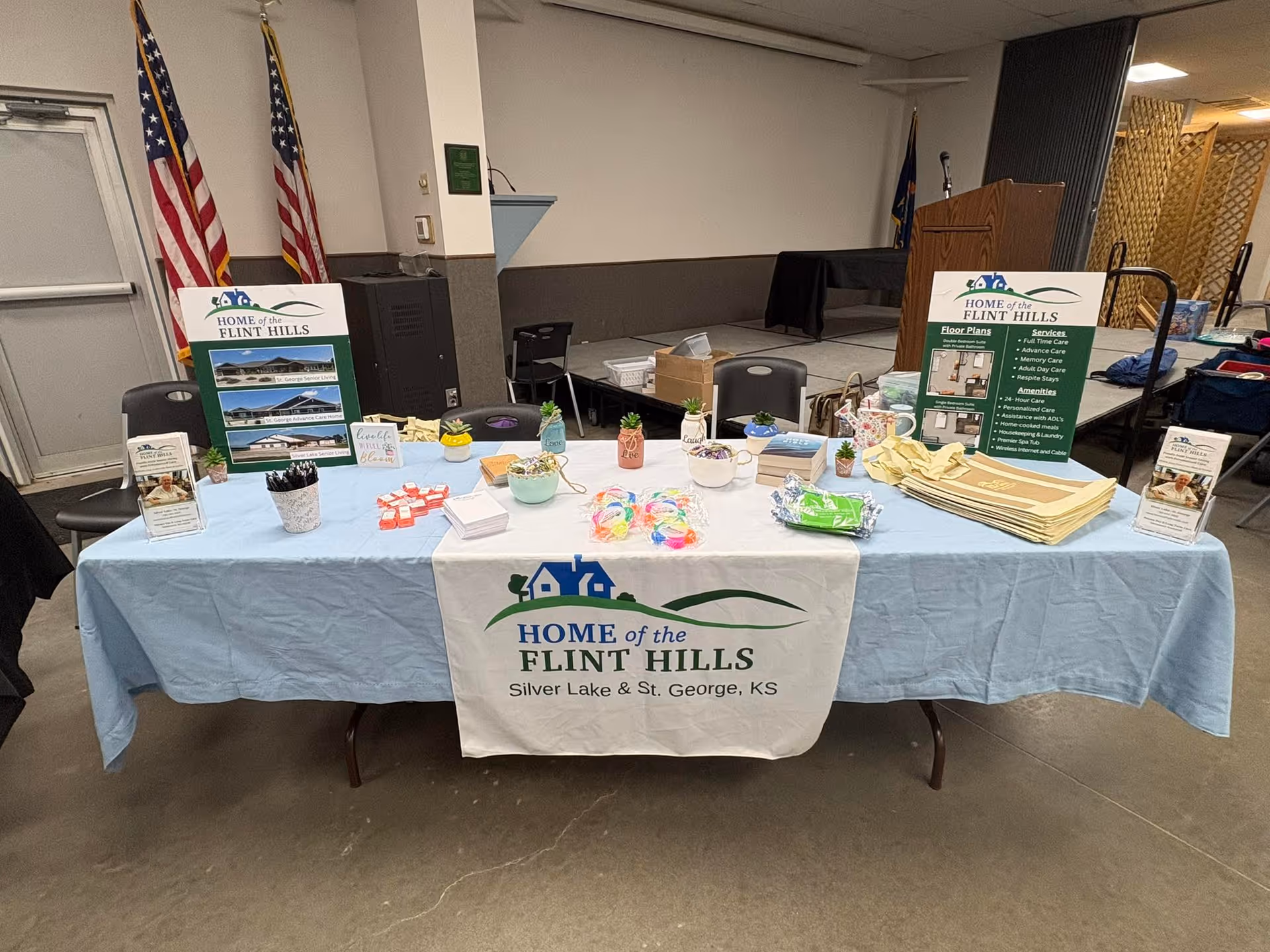 An information table with Home of the Flint Hills banner in a hall.