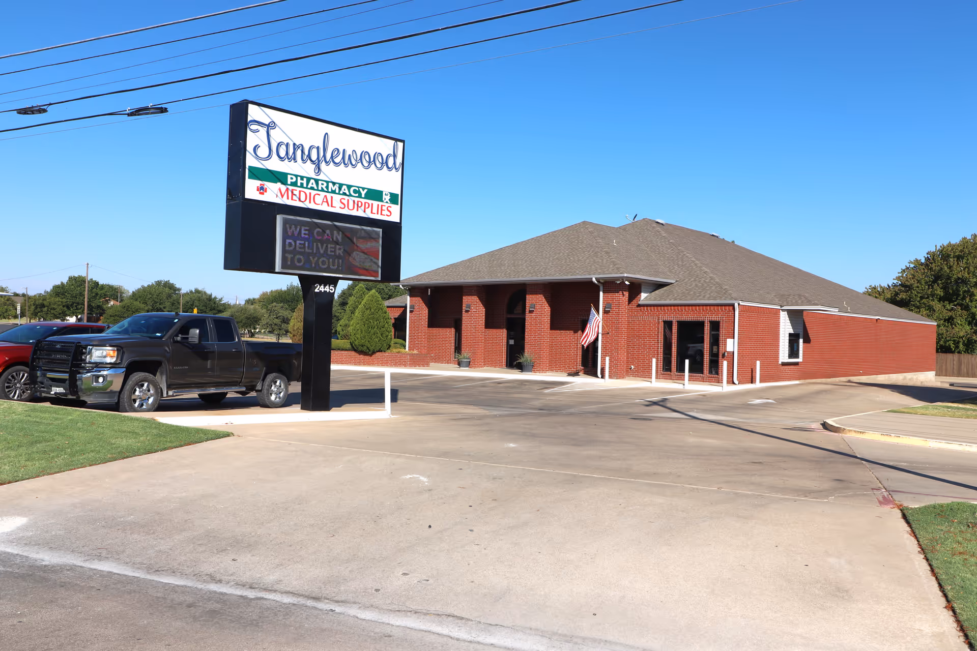Exterior view of Tanglewood Medical Supplies, a brick facility with a large sign and parking.