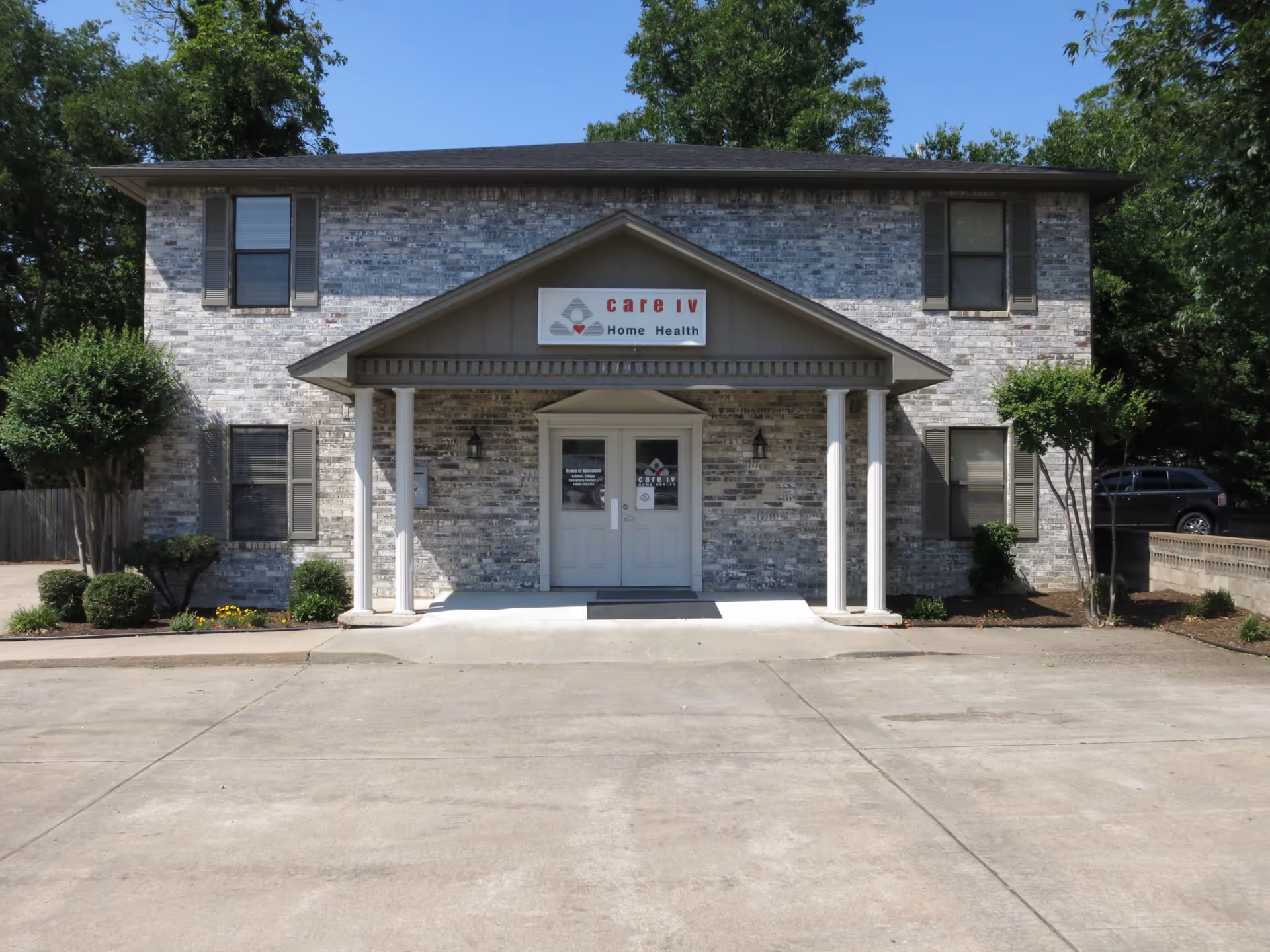 Two-story brick building with a covered entrance labeled Care IV Home Health.