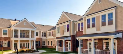 Exterior view of Valhalla Post Acute building cluster with brick and beige siding.