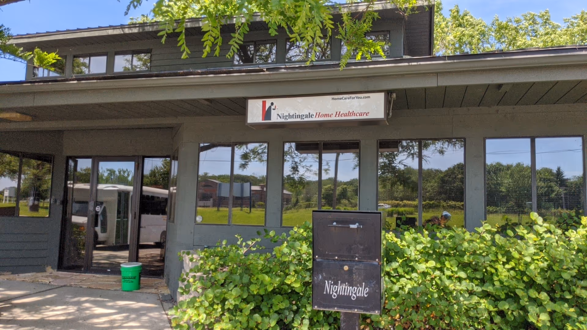 Exterior view of Nightingale Home Healthcare building with large windows and signage.