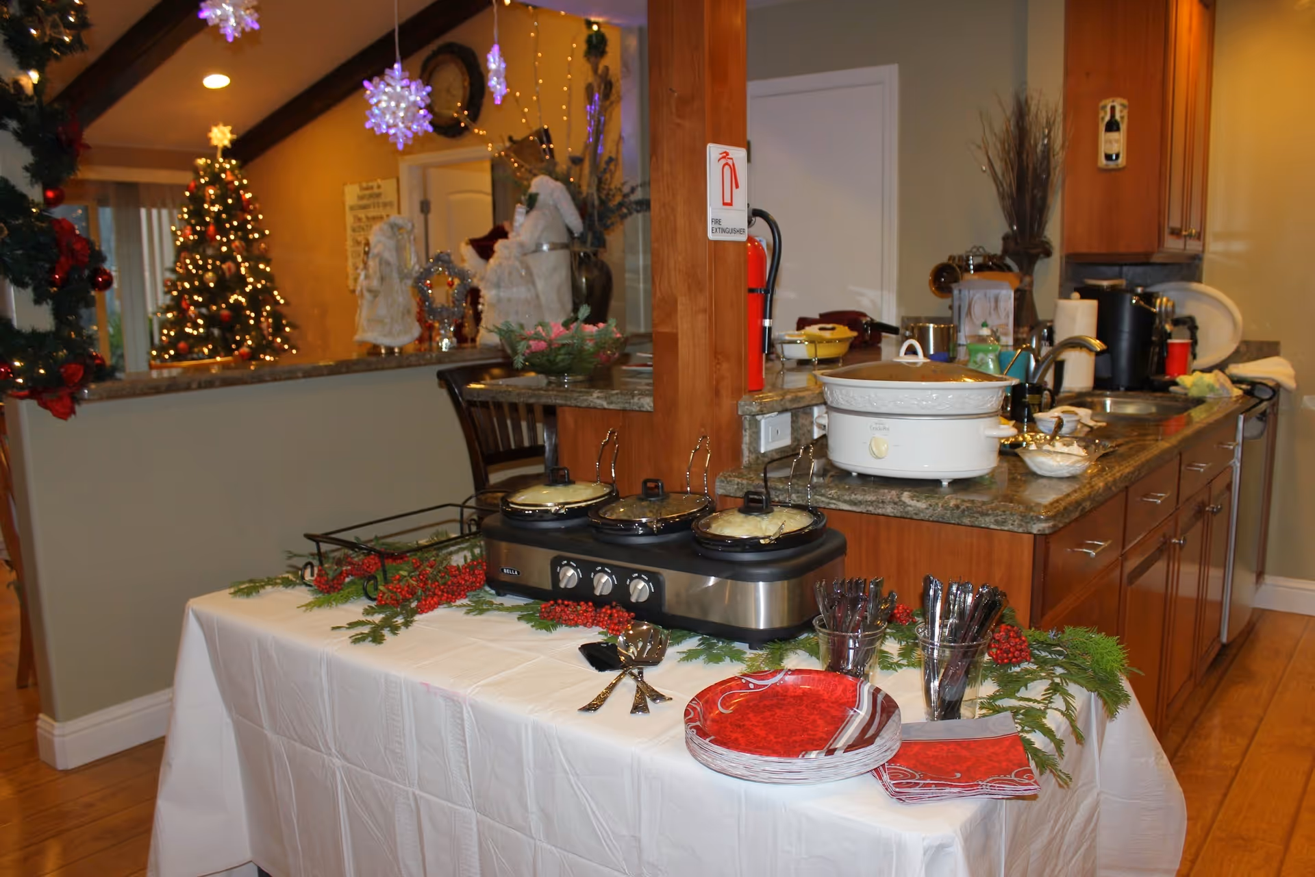 Interior dining area in a senior living facility with a decorated table and holiday decor.