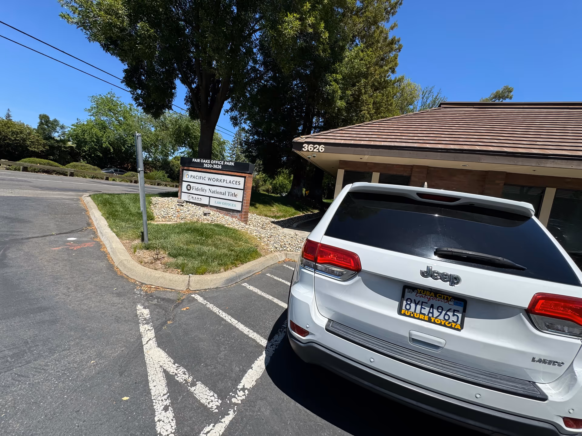 Exterior view of a building with a white Jeep parked in front.
