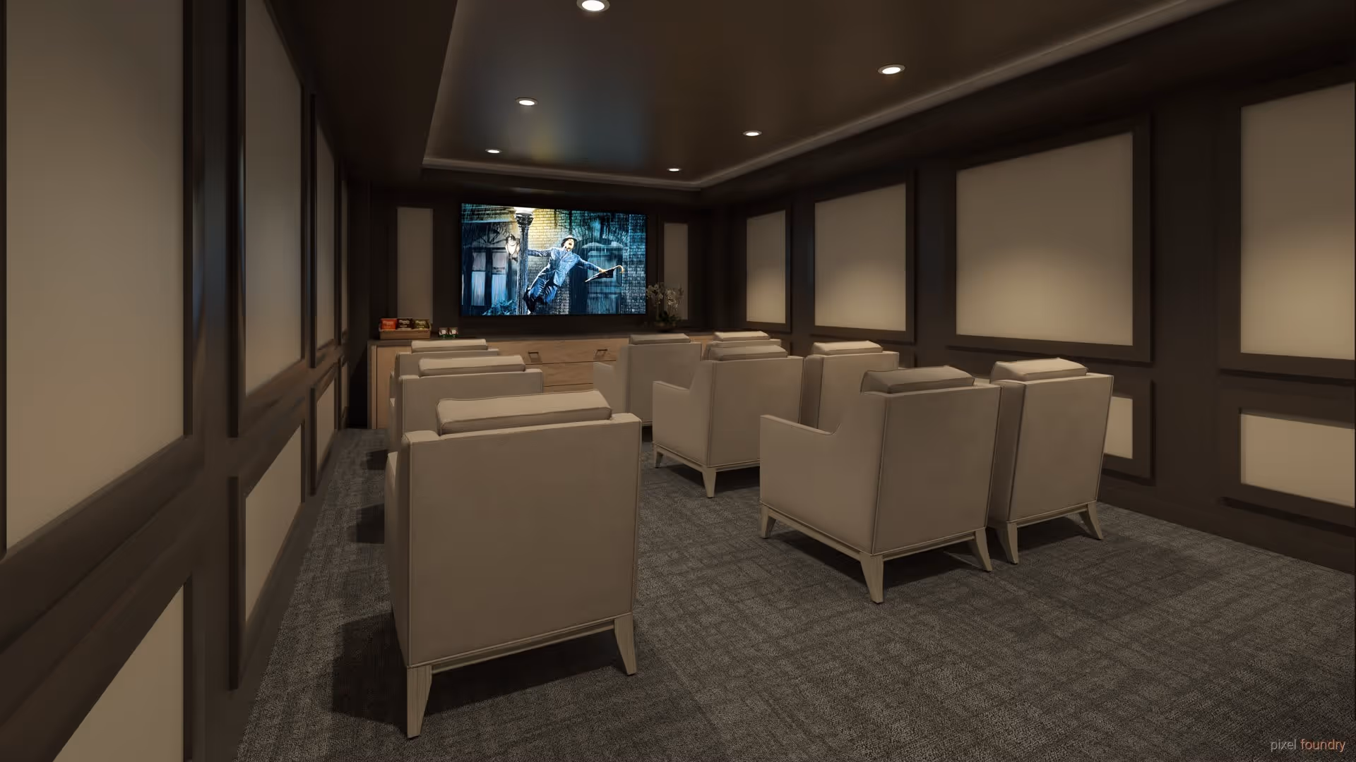 A small private movie theater room with two rows of beige armchairs facing a large screen showing a scene from a movie. The room has dark brown paneled walls with beige inserts and recessed ceiling lights. A small table with snacks is visible beneath the screen.