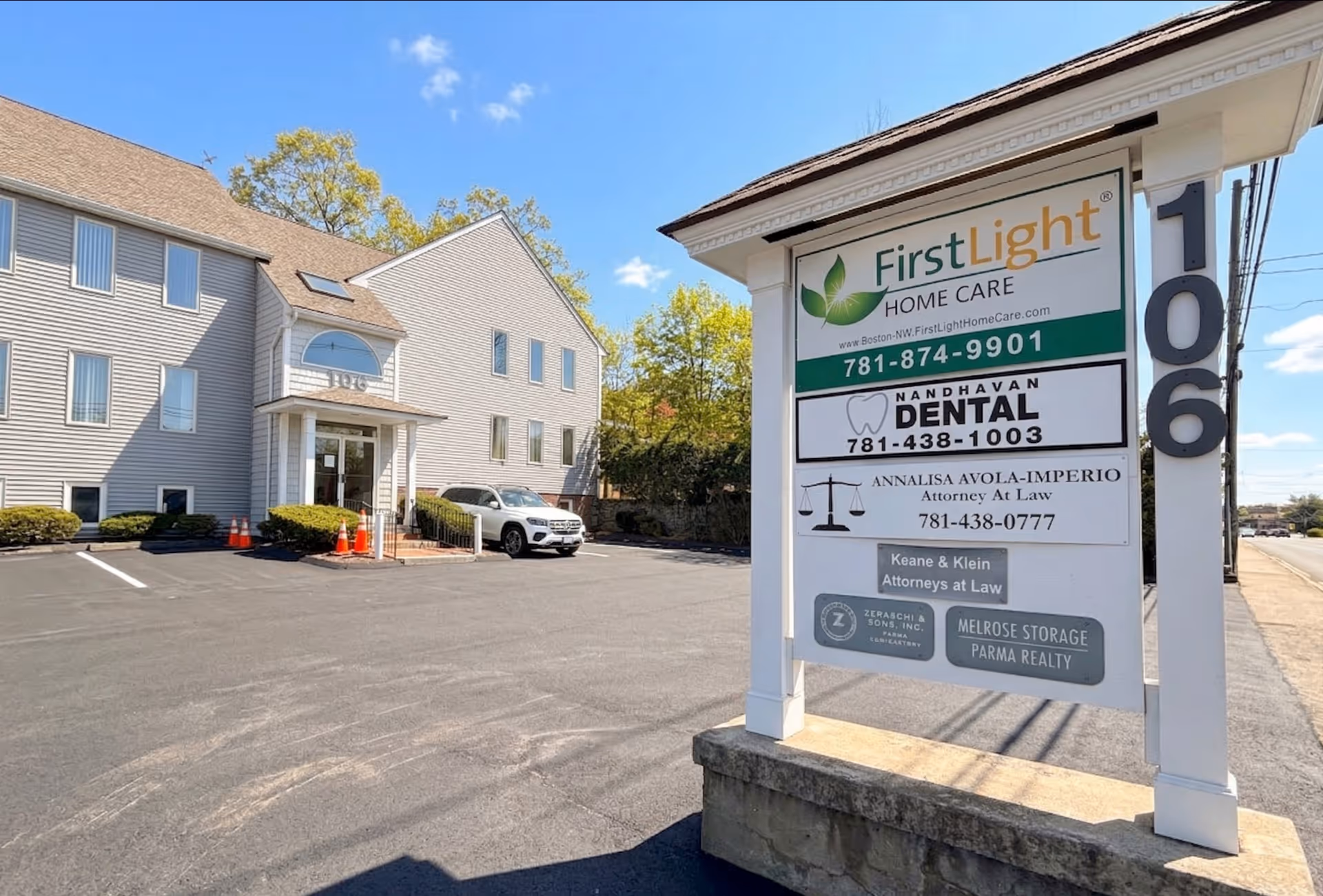 Exterior shot of a multi-unit building with a prominent FirstLight Home Care sign.
