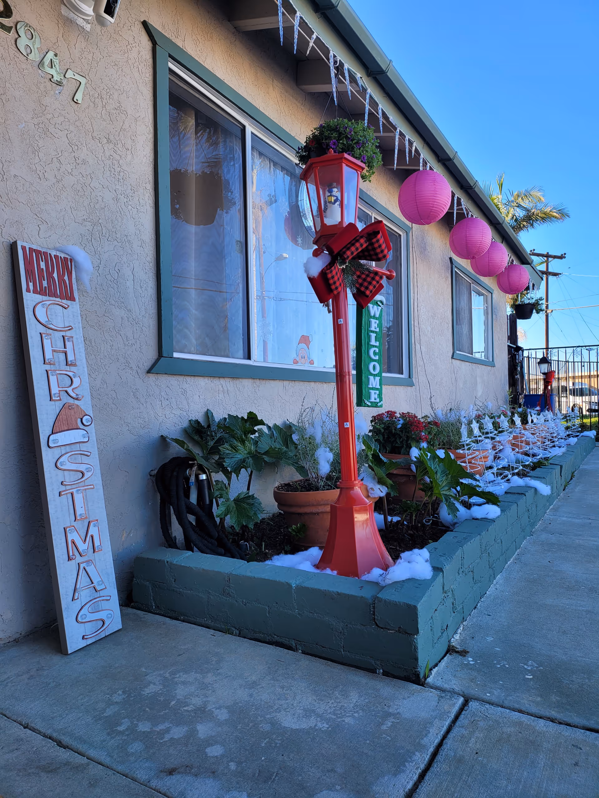 Exterior view of Morningside Manor with festive decorations and planters.