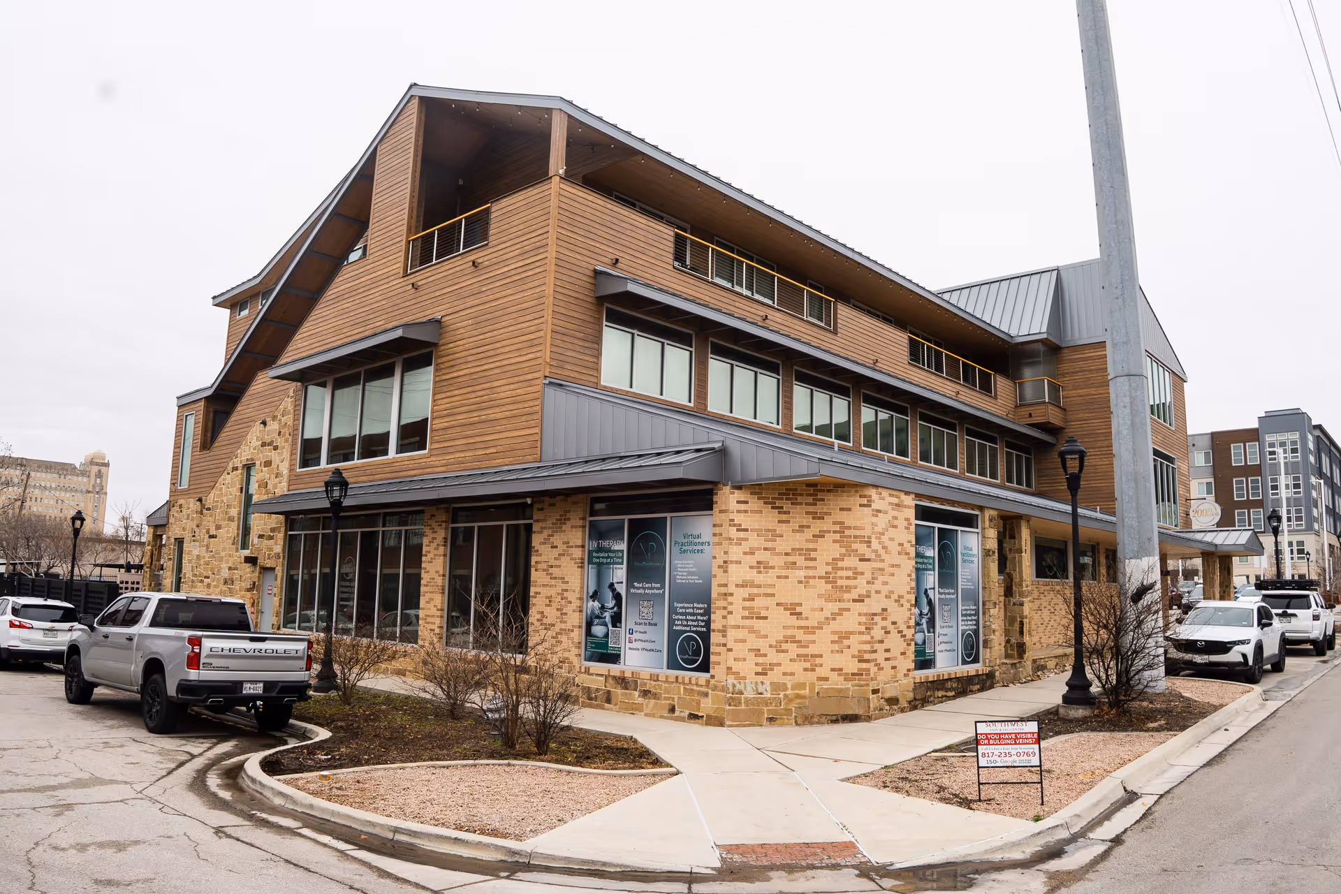 Exterior view of a modern senior living facility with brick and wood siding.