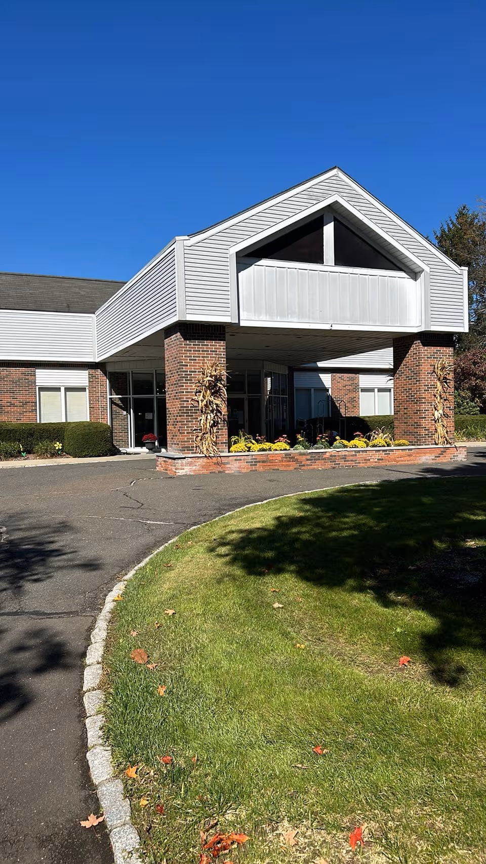 Exterior view of Wilton Meadows Nursing & Rehabilitation entrance with brick columns.