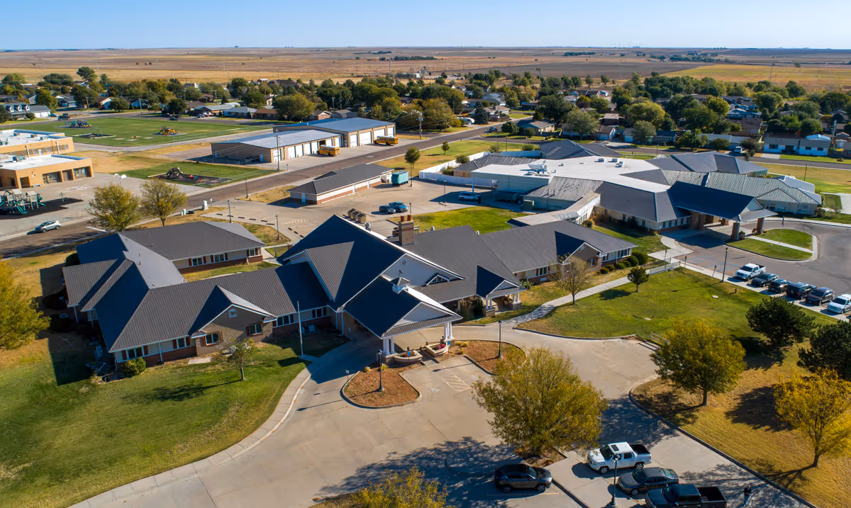 Aerial view of Western Prairie Assisted Living & Memory Care campus with multiple buildings and parking.