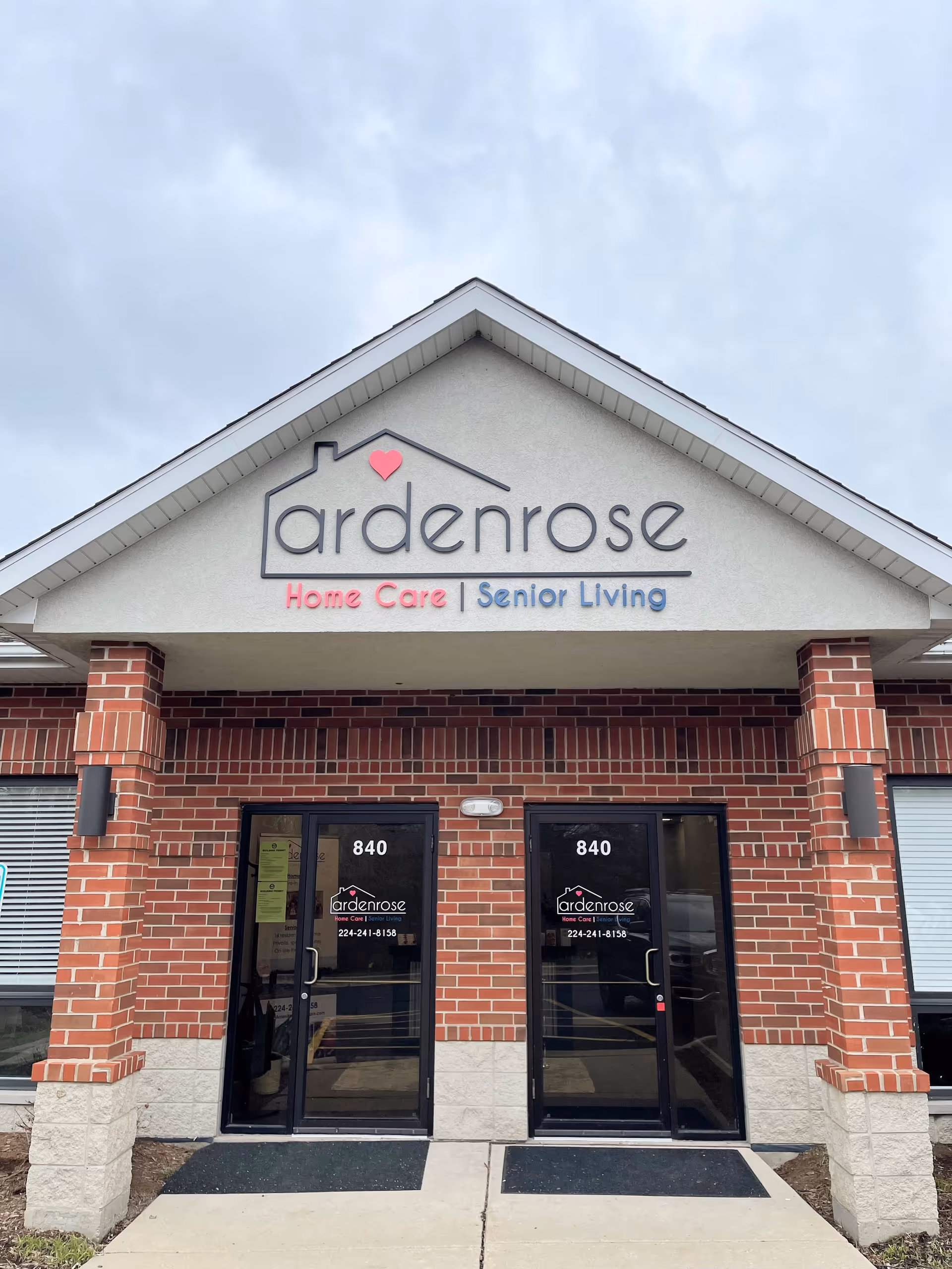 Brick storefront with Ardenrose sign and double glass doors at the entrance.