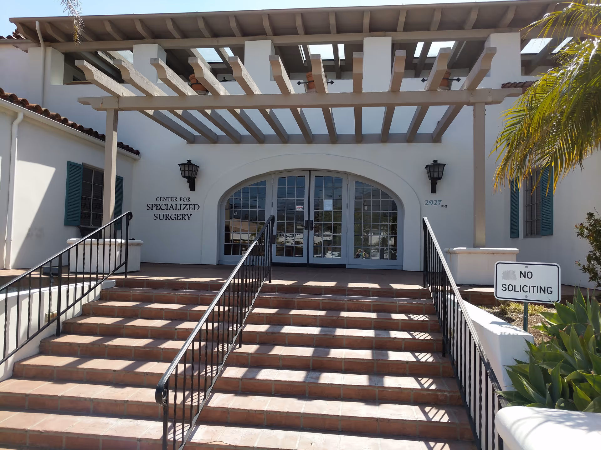 Exterior of The Center for Specialized Surgery with arched glass doors and a pergola.