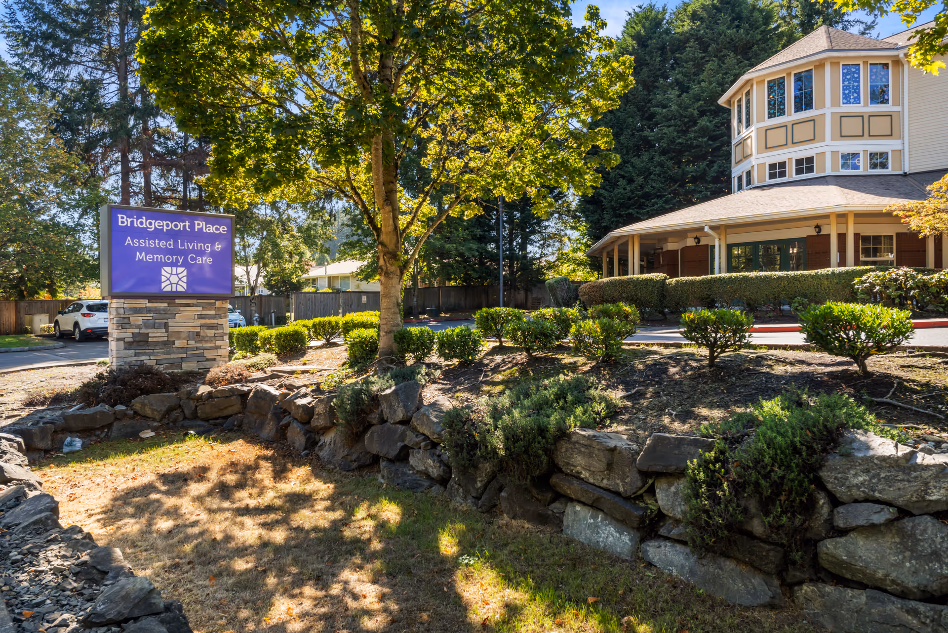 Bridgeport Place Assisted Living front exterior with sign and landscaped entry.