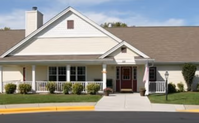 Front view of a single-story senior living facility with a porch and entrance.