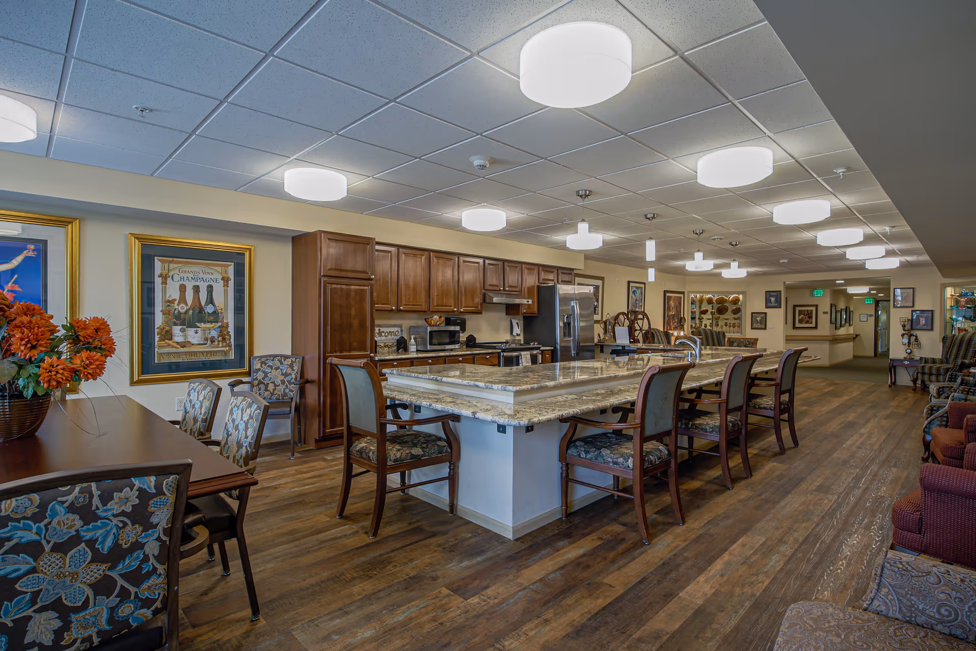 The Parkview II common area with a central granite island and dining seating.