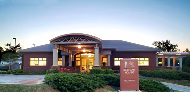 Front view of Compassus Bethany House senior living center with landscaped entrance.