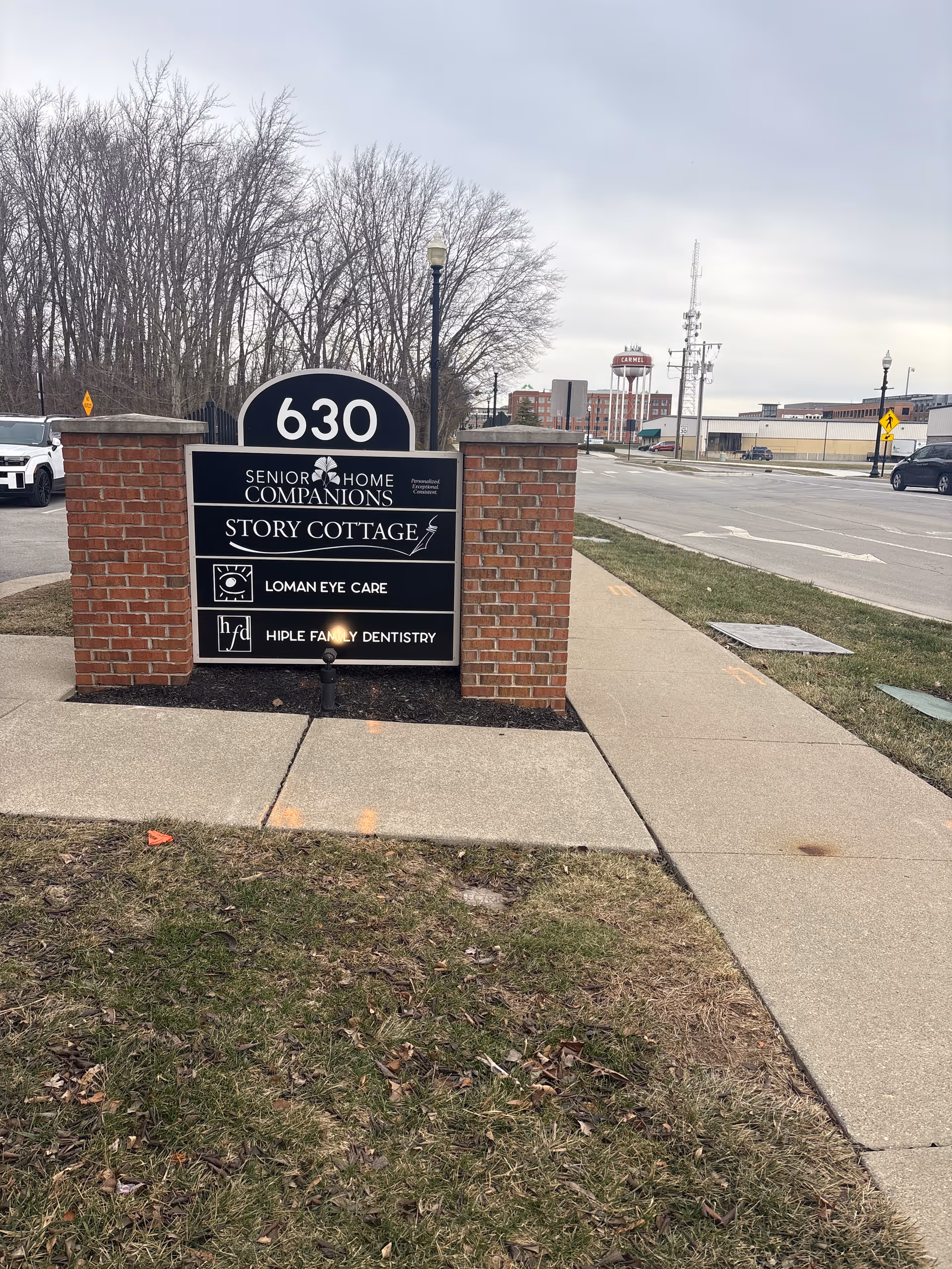 Exterior view of a brick sign for Senior Home Companions and Story Cottage.