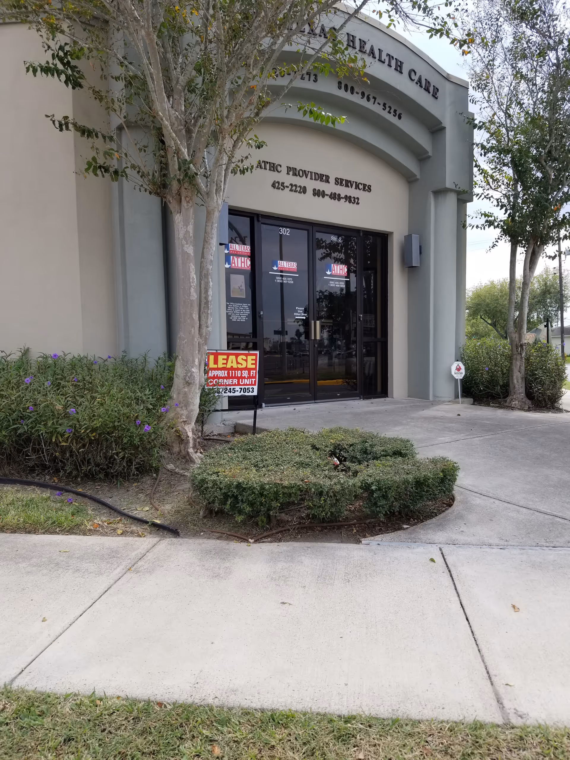 Exterior view of ATHC Provider Services building entrance with glass doors.