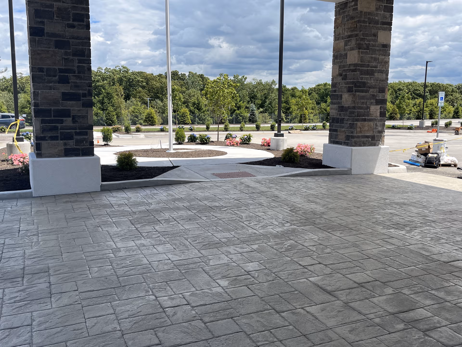 The outdoor entrance of Pleasant Hill Retirement Community with stone columns and paved walkway.