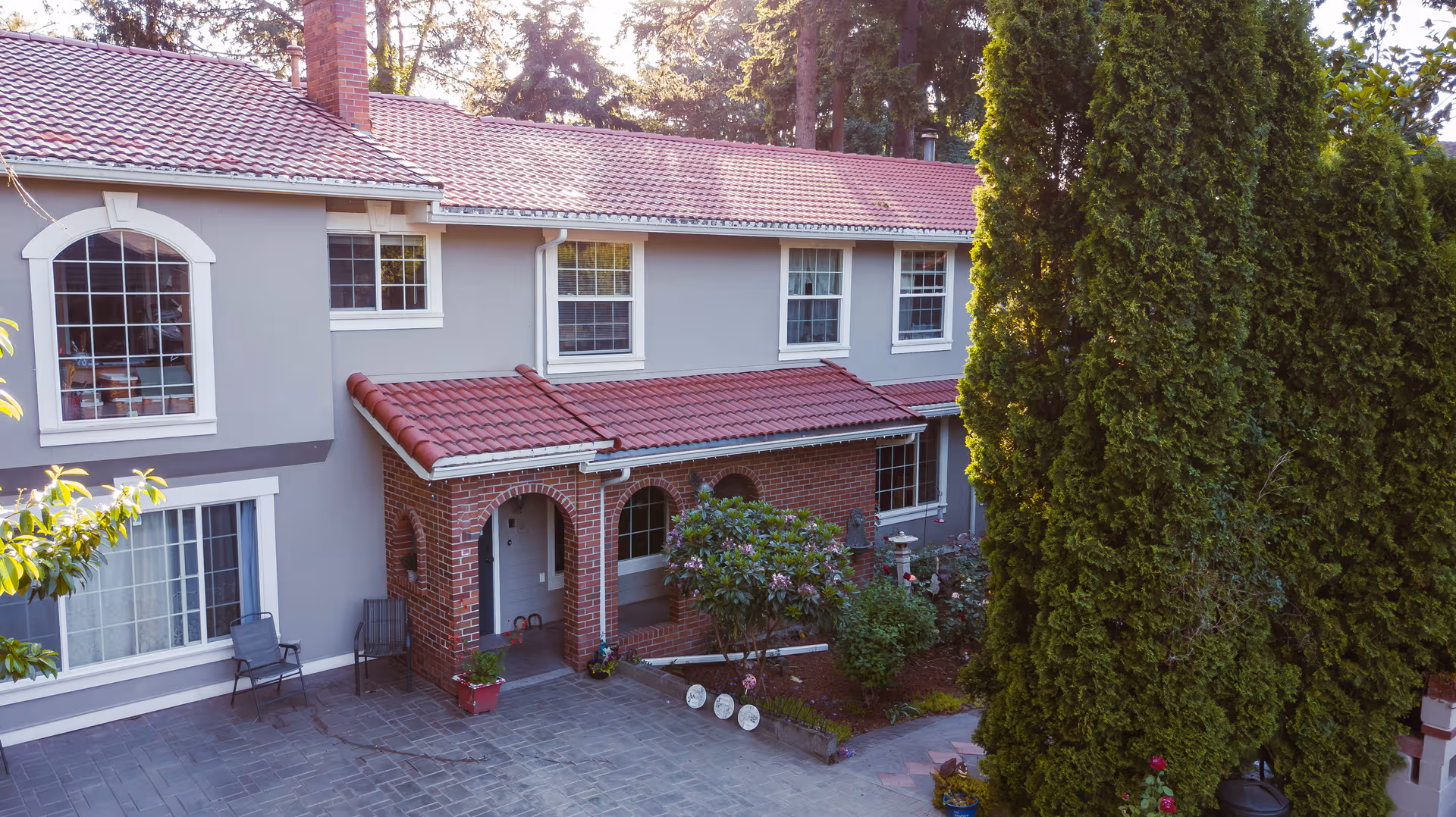 Exterior view of Alpine House SW Portland: two-story building with red-tiled roof.