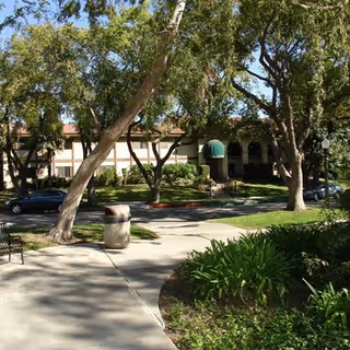 Exterior view of Parkview of Glendale with trees, sidewalk, and arched entrance.