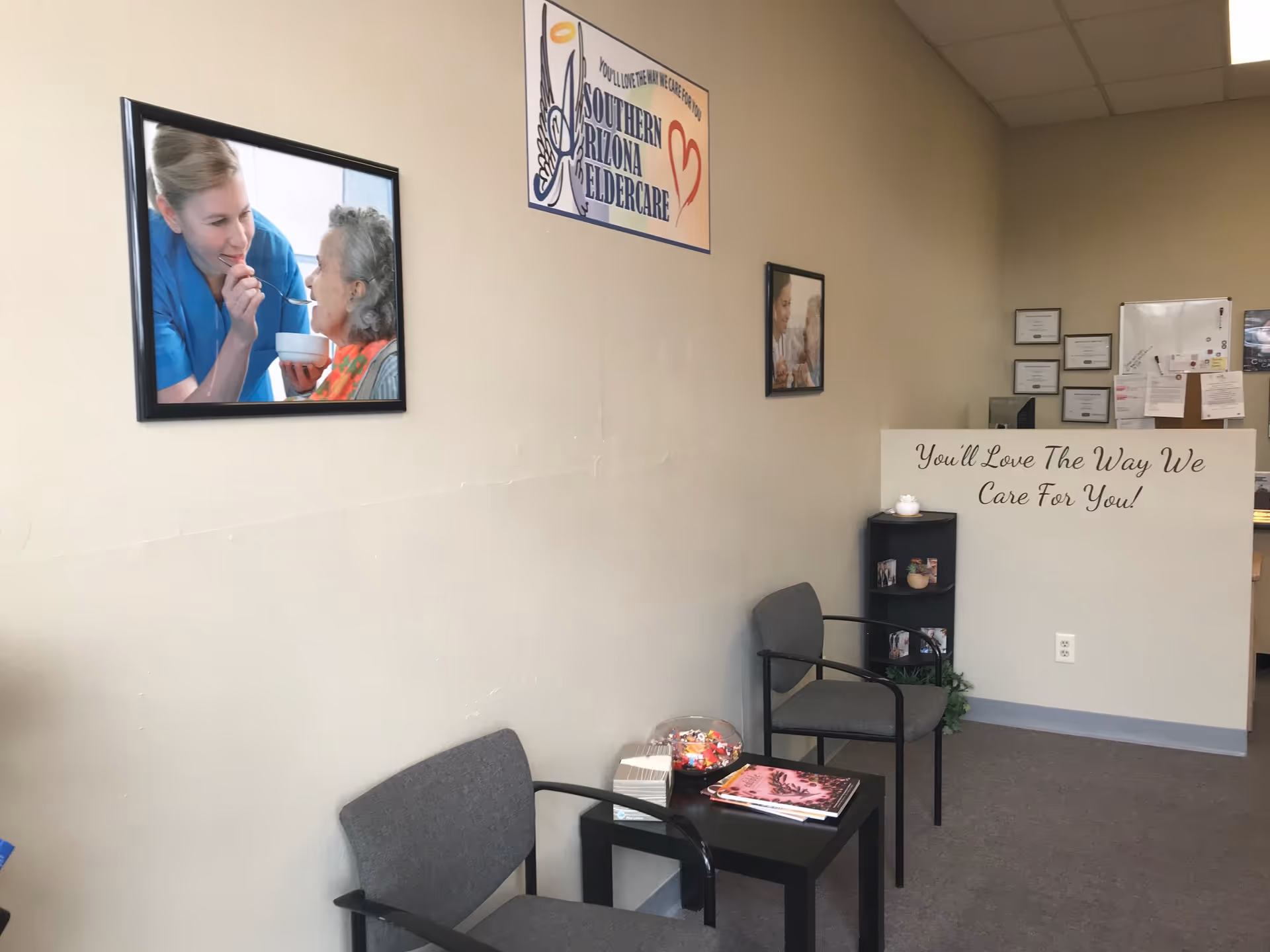 A waiting area in a senior care facility with chairs, magazines, and wall art.