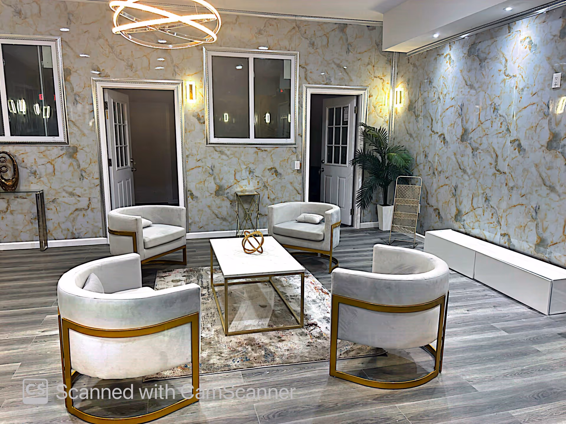 Modern senior living lounge with circular white chairs around a coffee table.