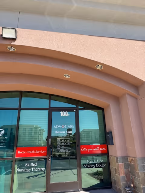 Exterior view of Advocare building entrance with curved arch and glass doors