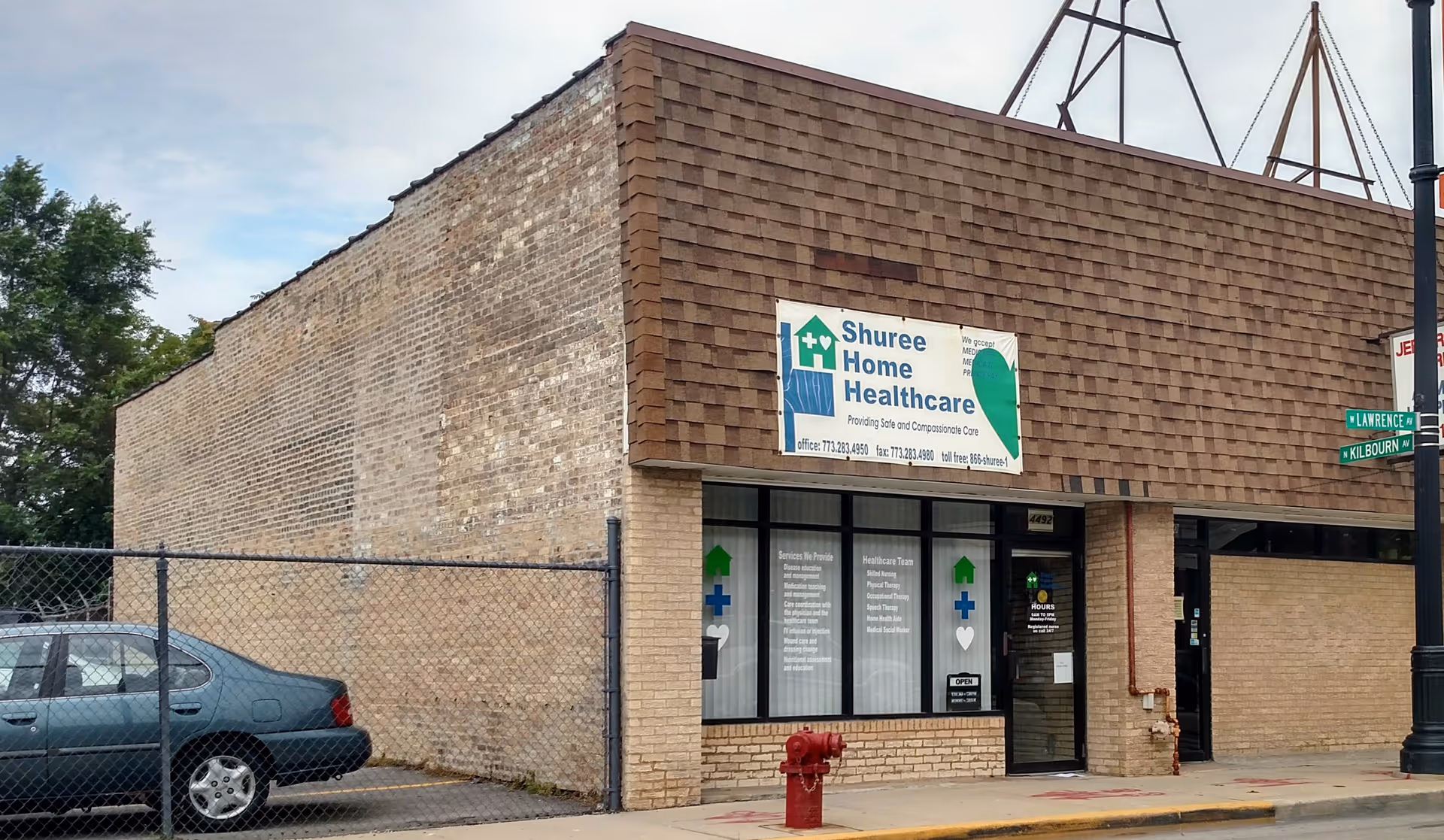 Exterior view of Shuree Home Healthcare building with brick facade and storefront windows.