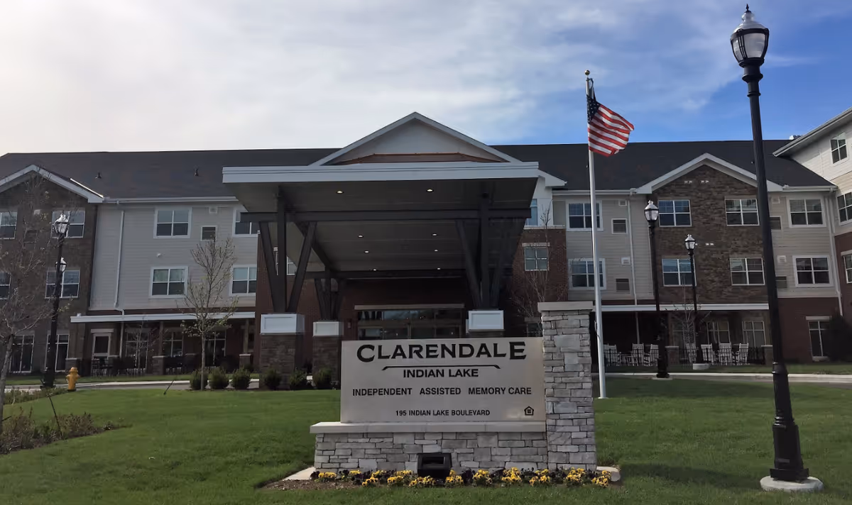 Exterior view of Clarendale at Indian Lake with entrance canopy and manicured lawn.