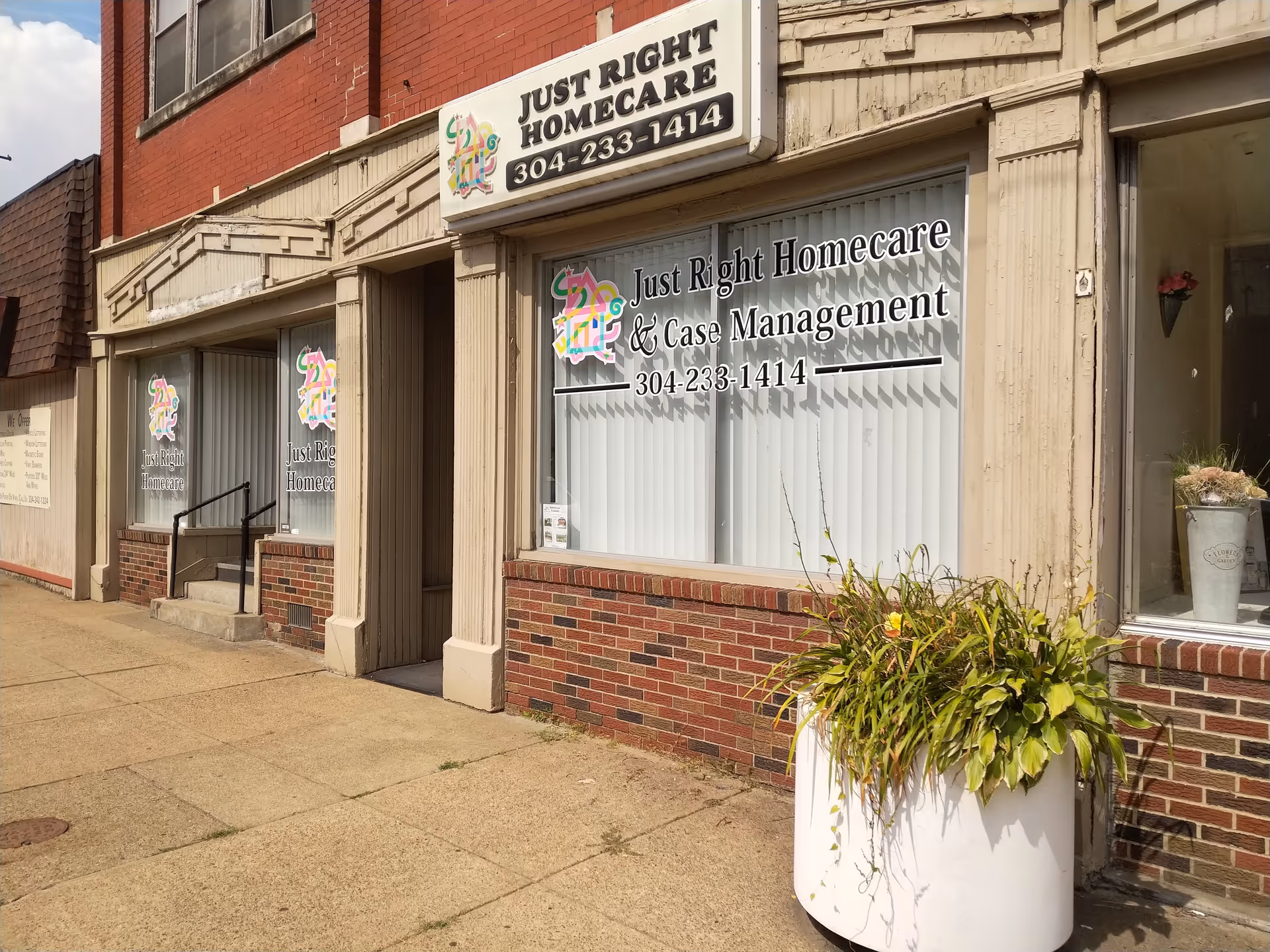 Storefront of Just Right Homecare with large window sign and a planter outside