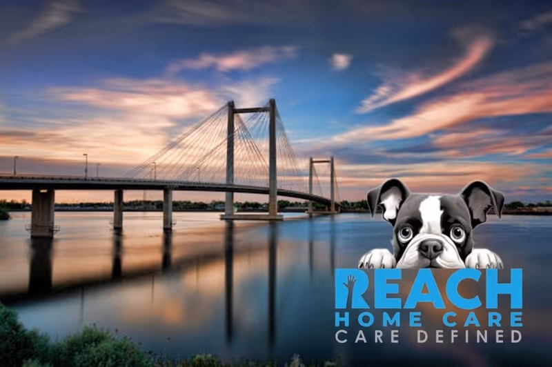Sunset view of a bridge over water with Reach Home Care logo and dog mascot