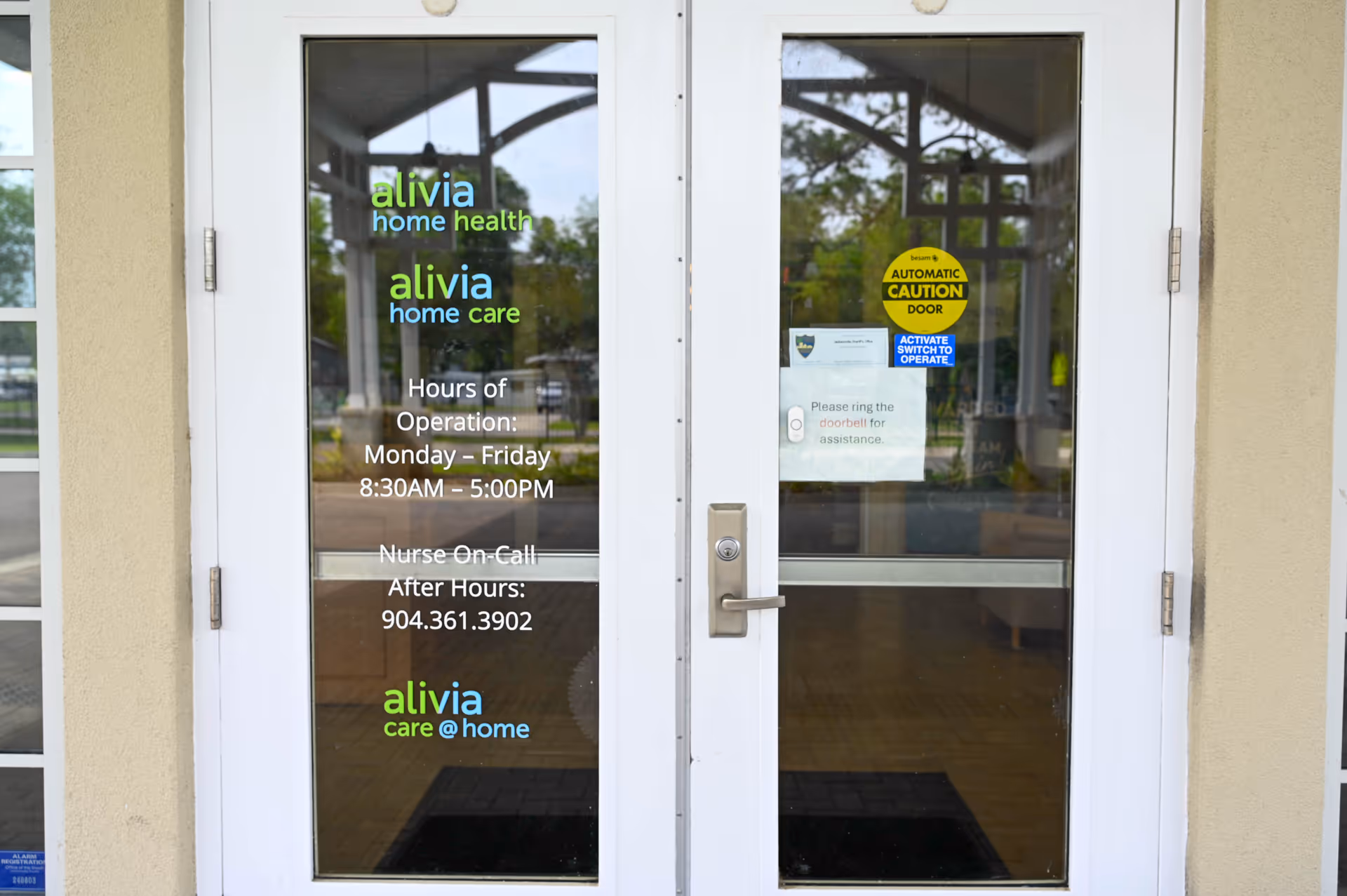 Double glass doors with Alivia Care @ Home signage at the front entrance.