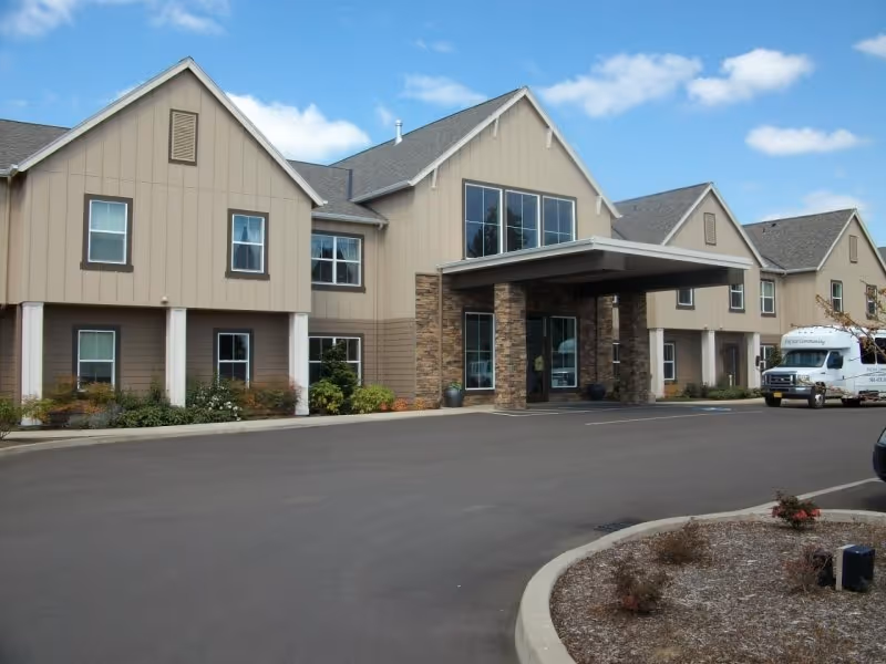 Fircrest Senior Living exterior with a covered entrance and parked van.