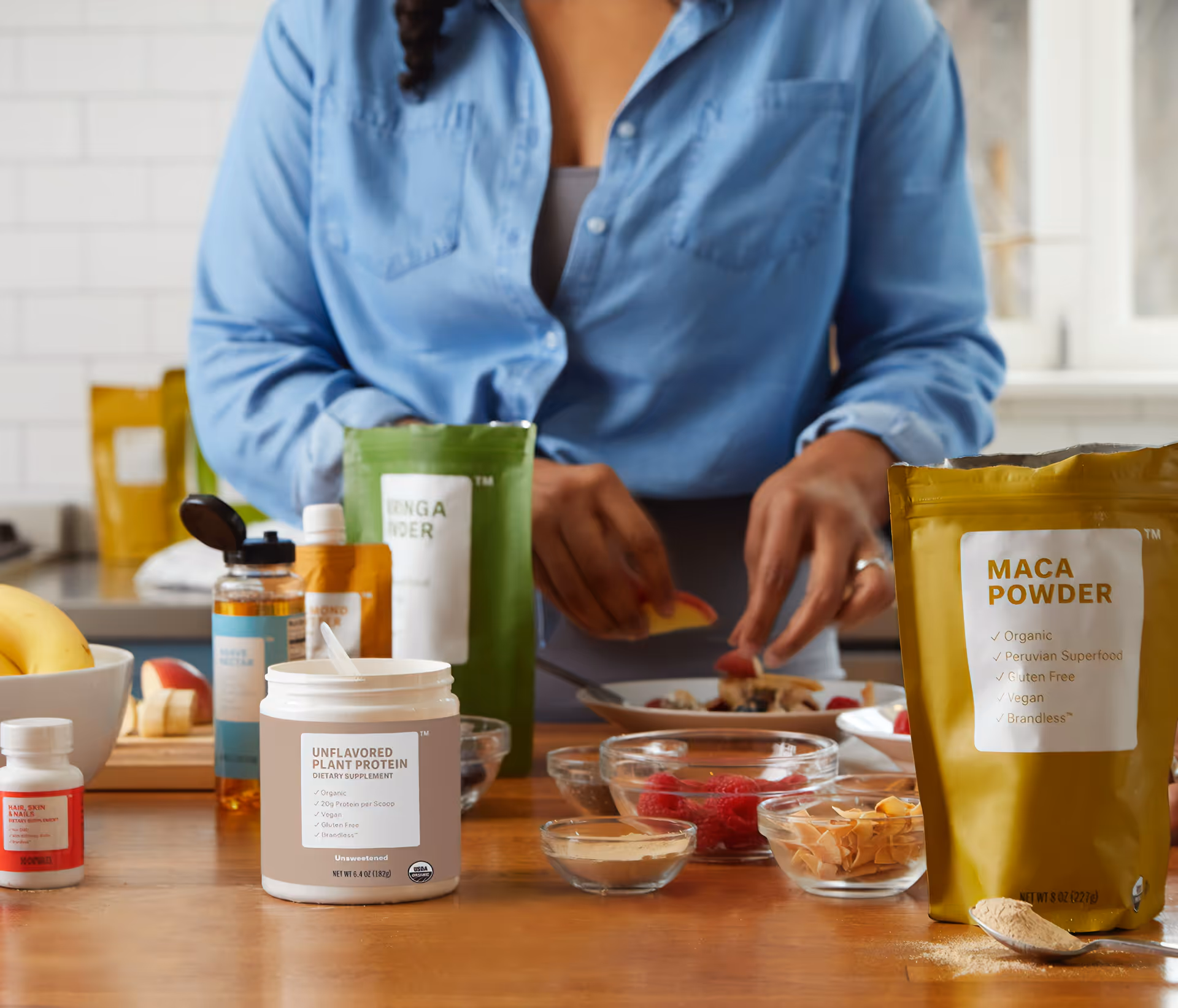 Person in blue shirt prepares ingredients on a kitchen counter with powders.