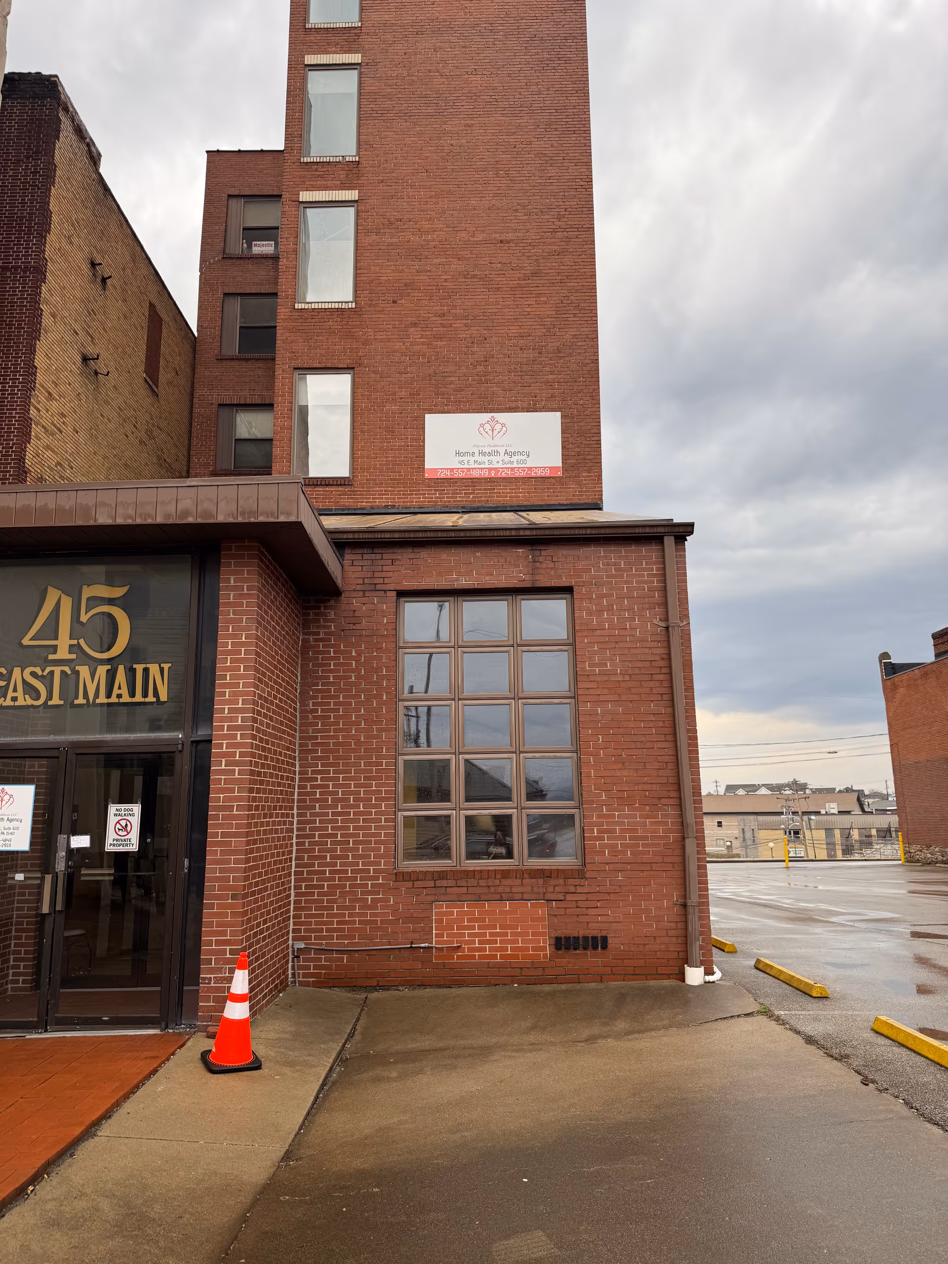 Brick building exterior with large windows and a glass entrance labeled 45 East Main.