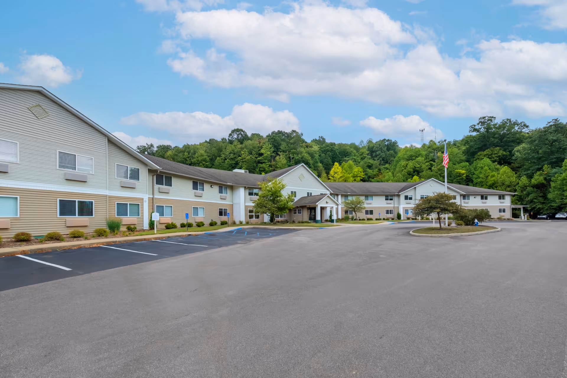 Exterior view of Brookdale Charleston Gardens with a long, low-rise building and parking lot.