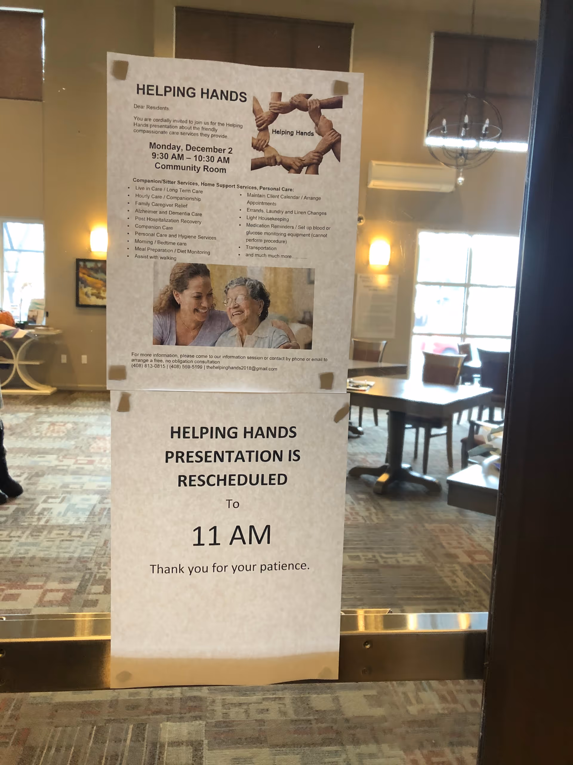 Two Helping Hands notices posted on glass door in a lounge area.