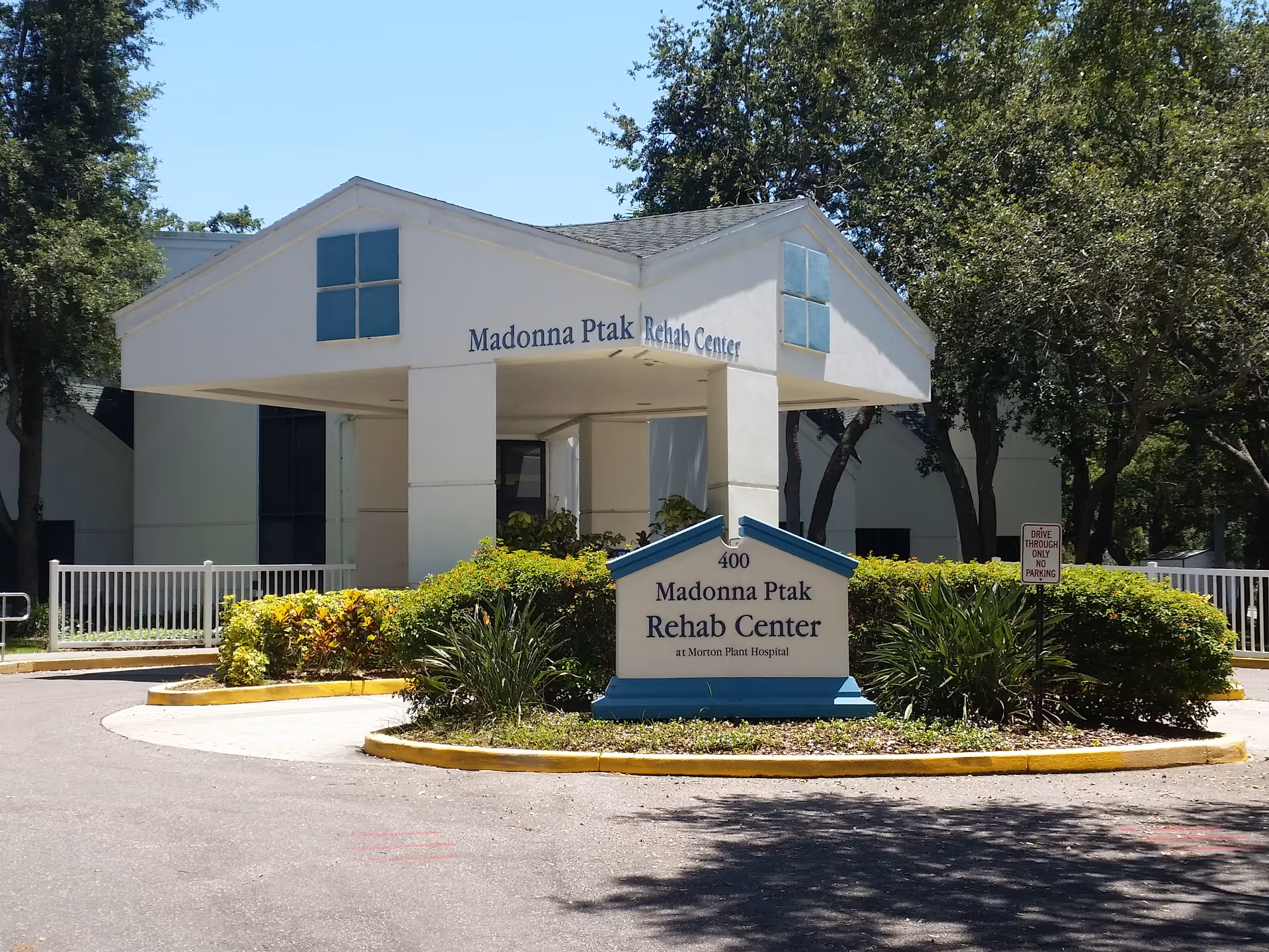 Front view of Madonna Ptak Rehab Center building with signage and landscaped entrance.