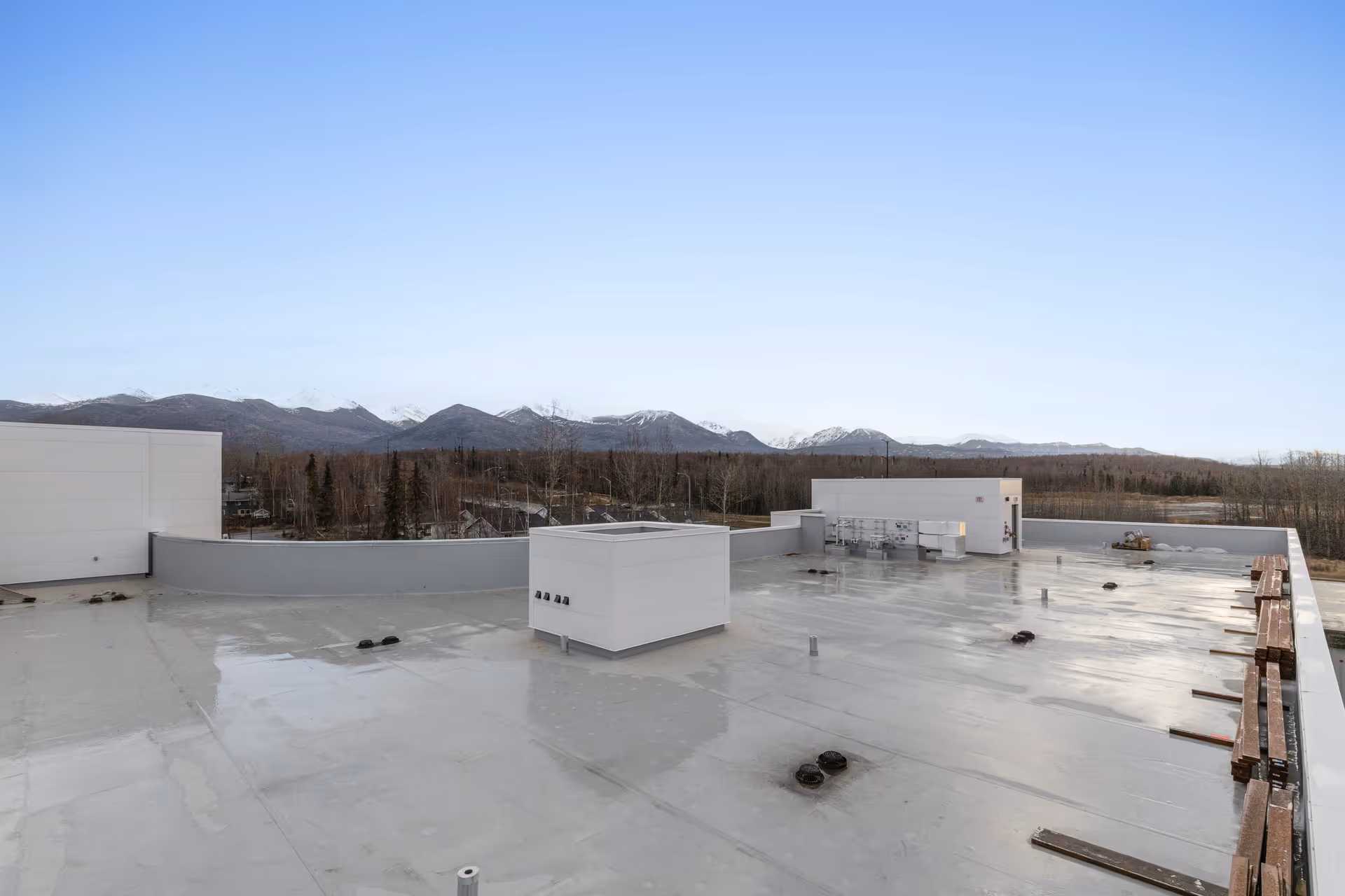 Rooftop view from Baxter Senior Living with distant mountains and clear blue sky.