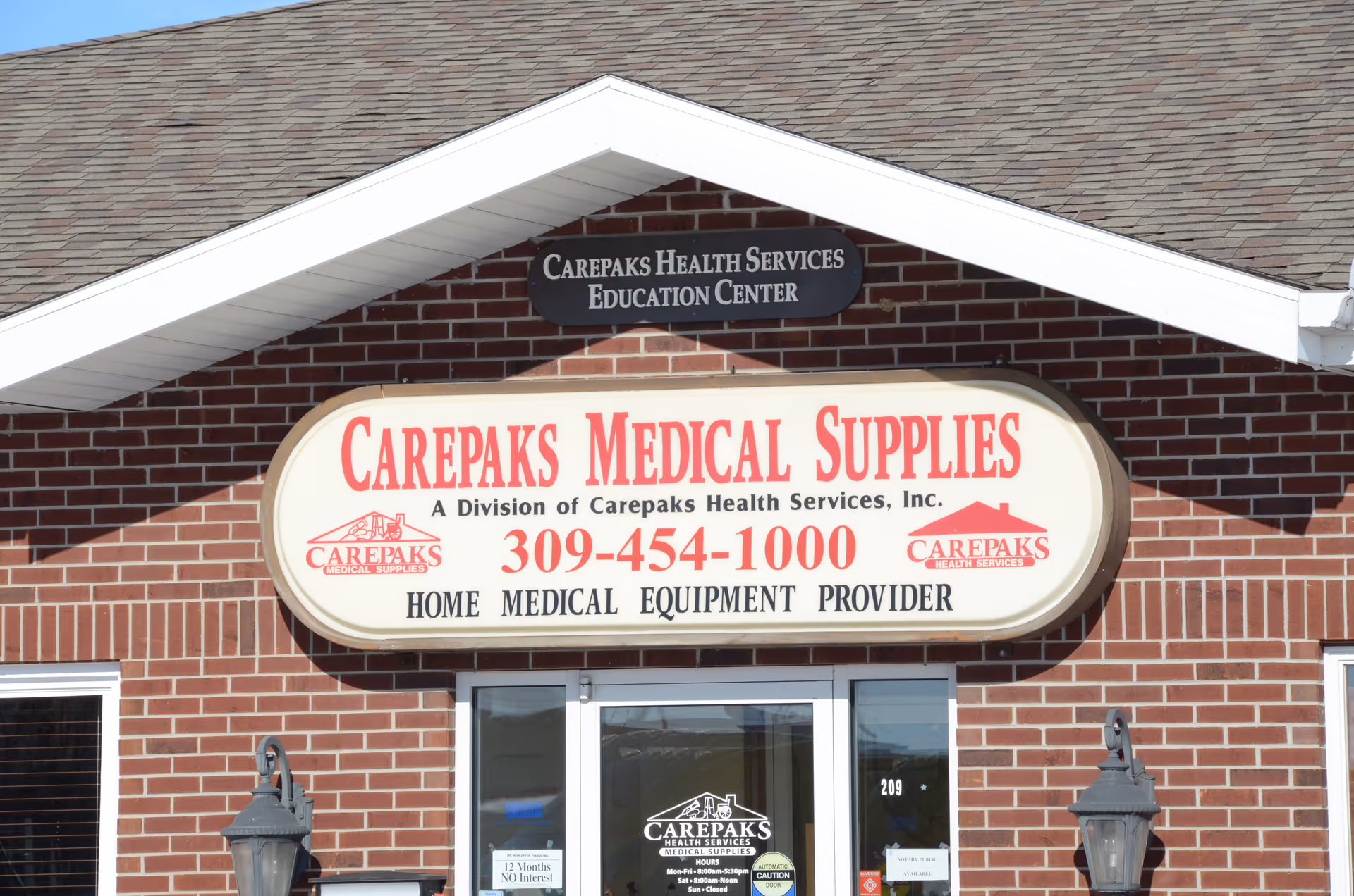 Front view of a brick building with a large Carepaks Medical Supplies sign.