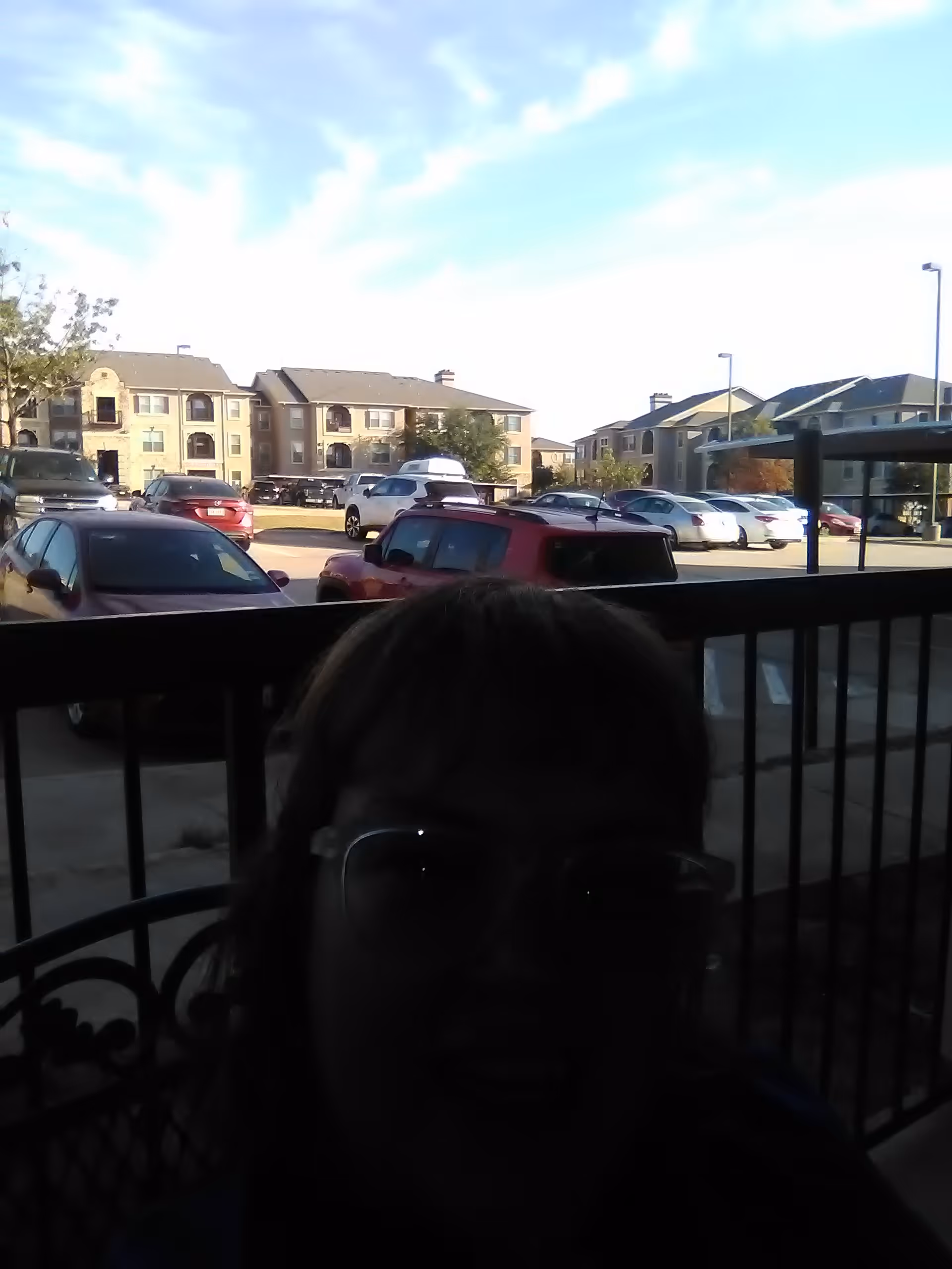 Outdoor parking lot in front of a senior living facility with parked cars