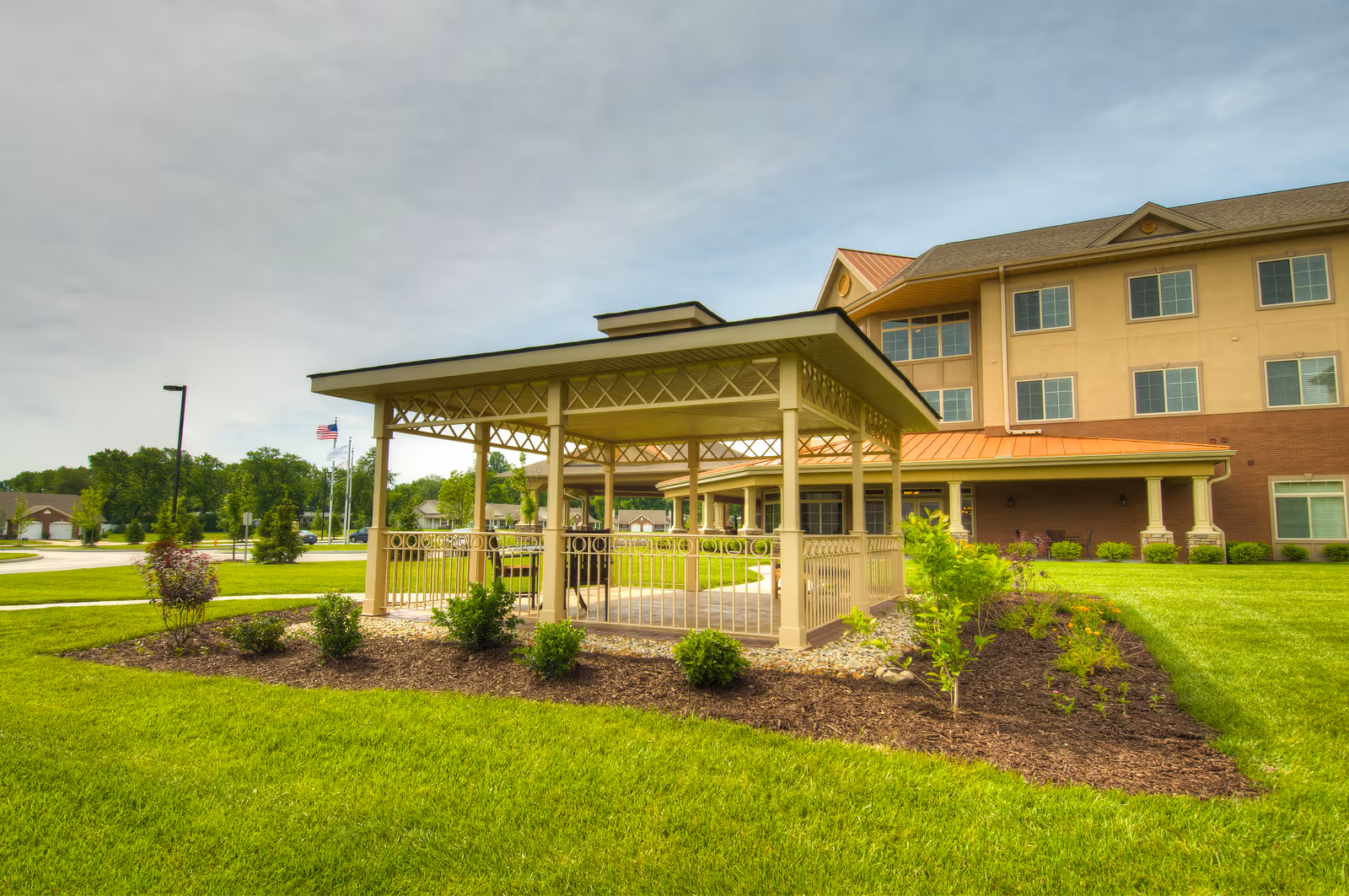 Exterior view of Garden Plaza of Florissant with entrance gazebo and manicured lawn.
