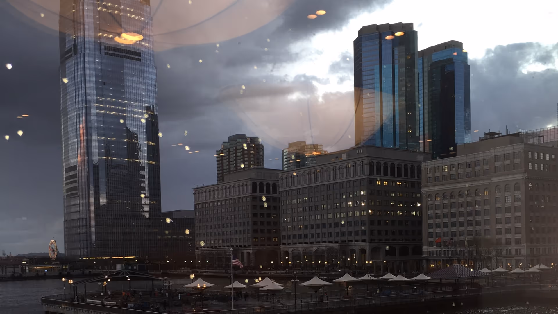 City skyline along the waterfront, reflected in a glass window.