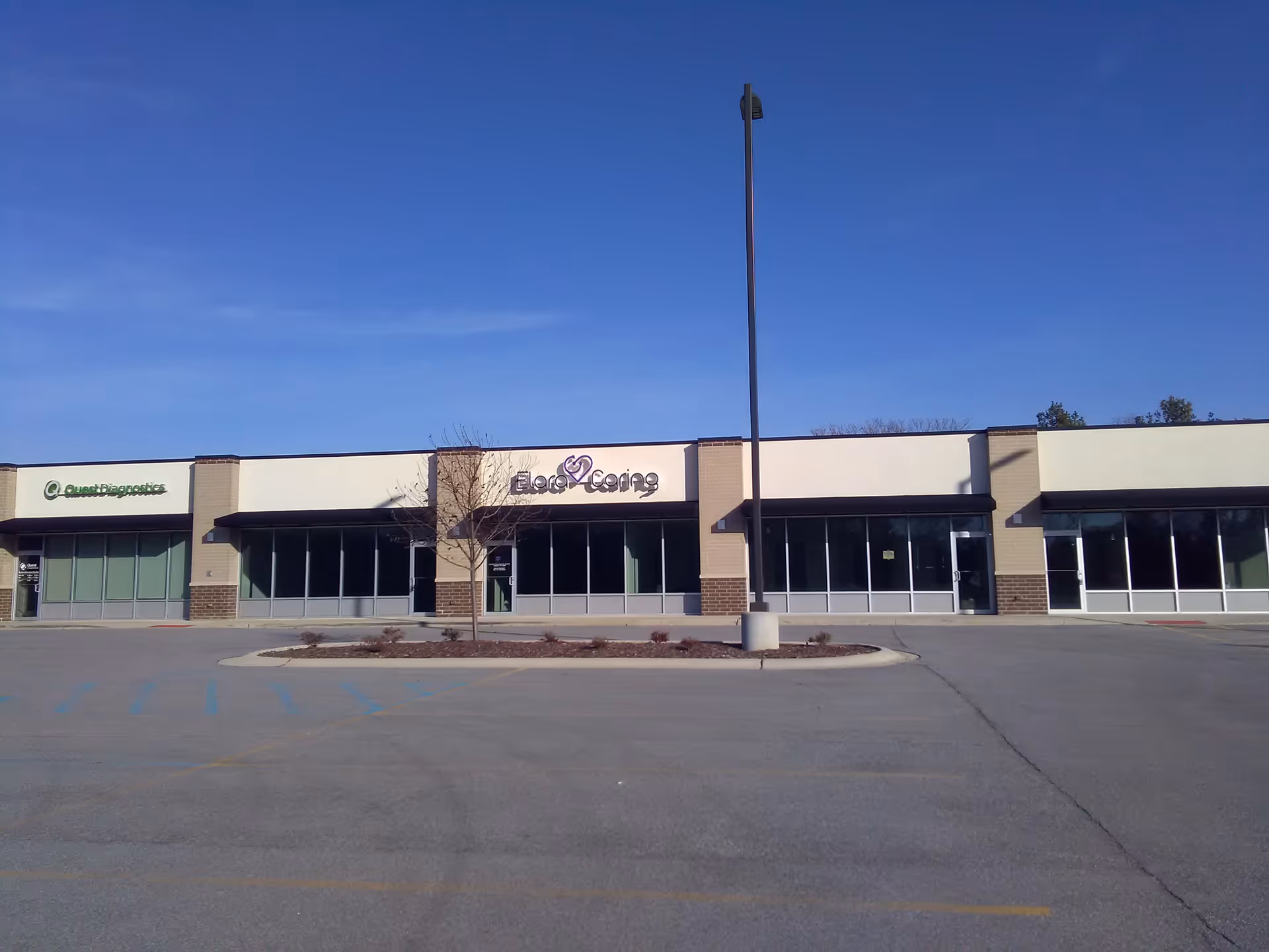 Front view of a single-story building with Elara Caring signage and parking lot.