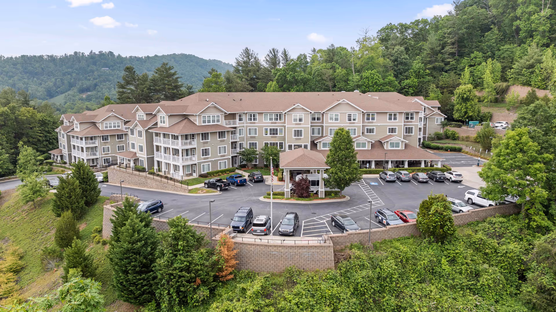 Exterior view of Bella Vista Gracious Retirement Living building with parking and surrounding greenery.