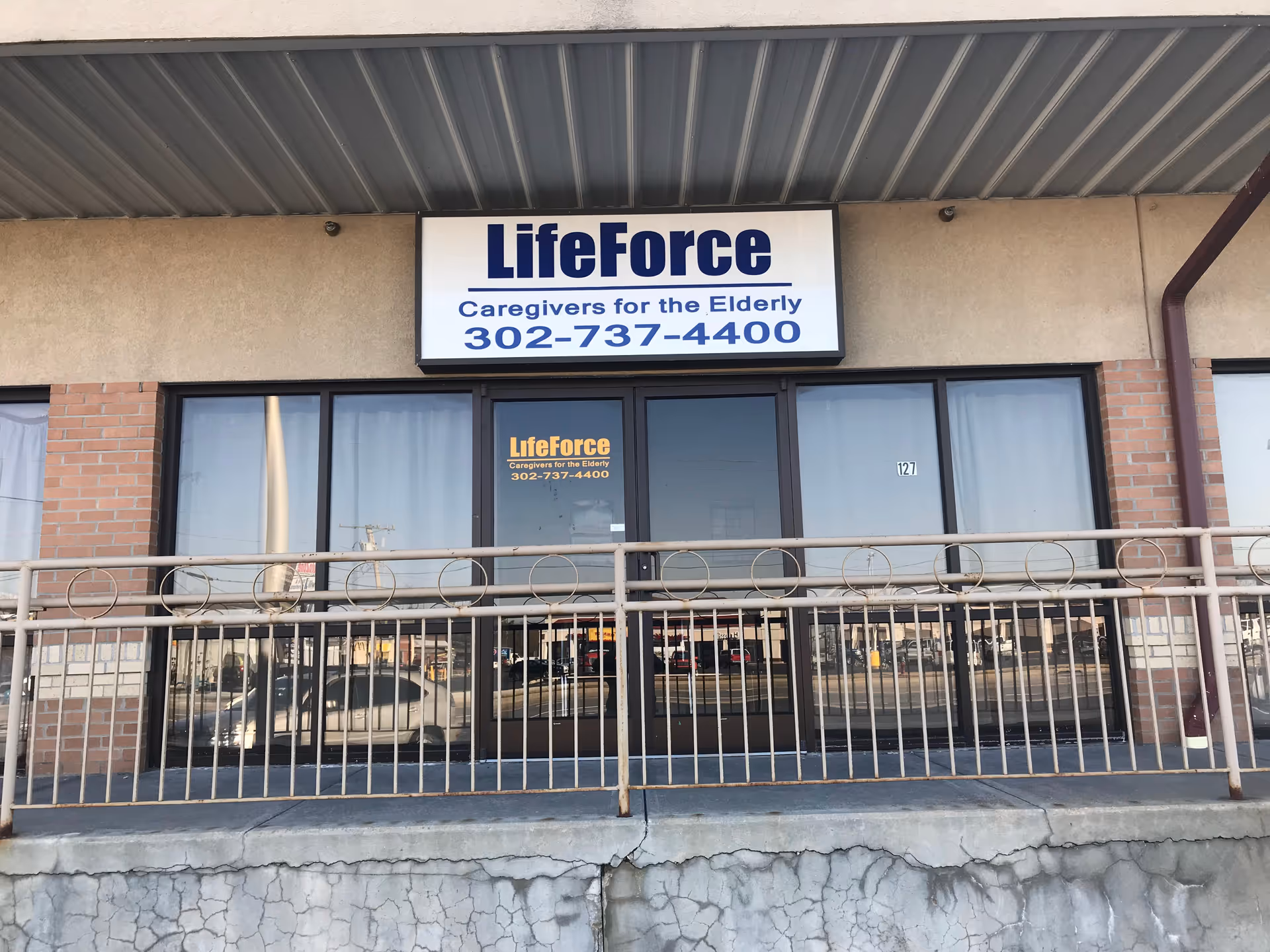 Front facade of LifeForce Caregivers for the Elderly storefront with glass doors.