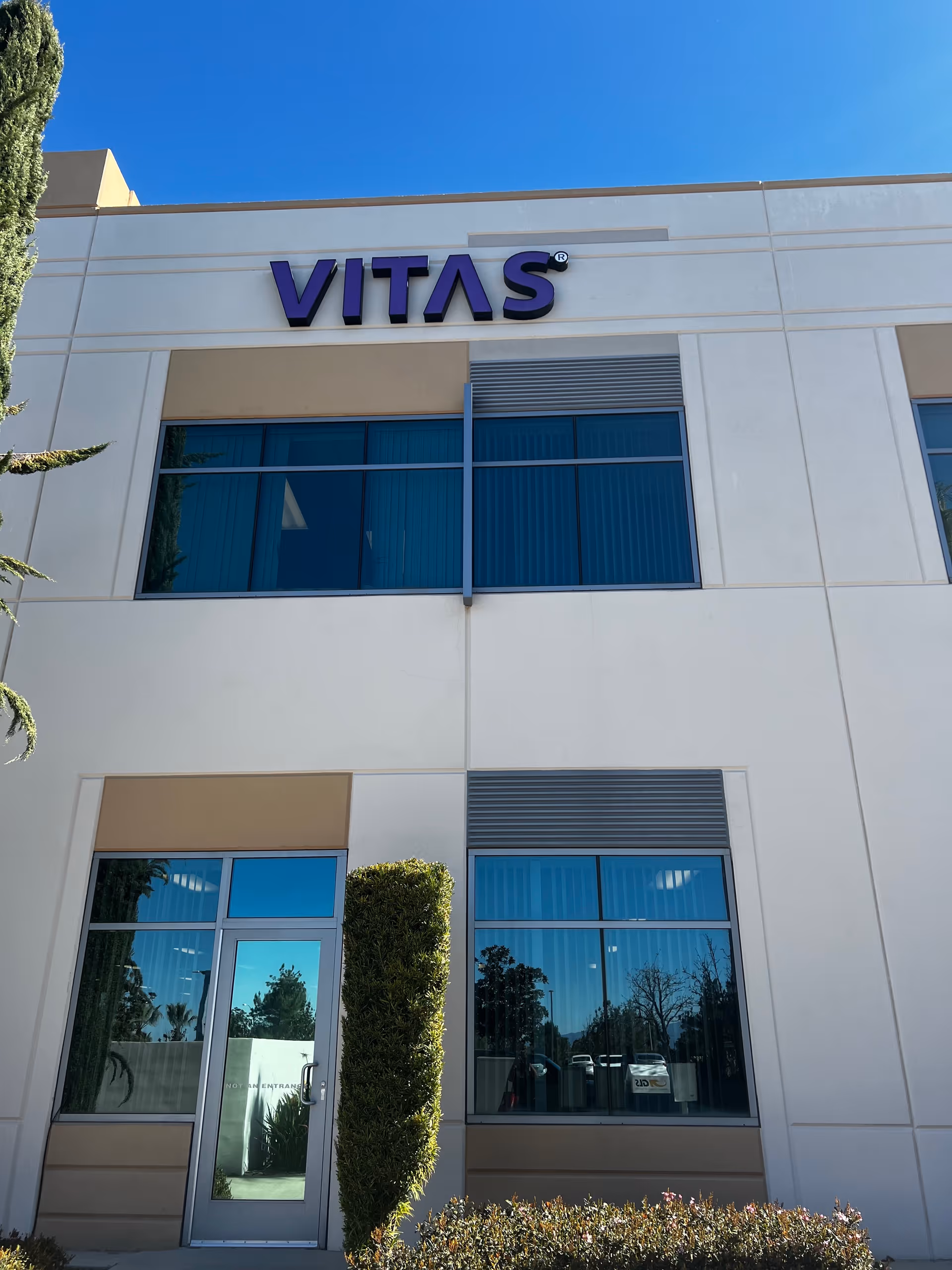 VITAS Healthcare building front with large windows and a glass door.