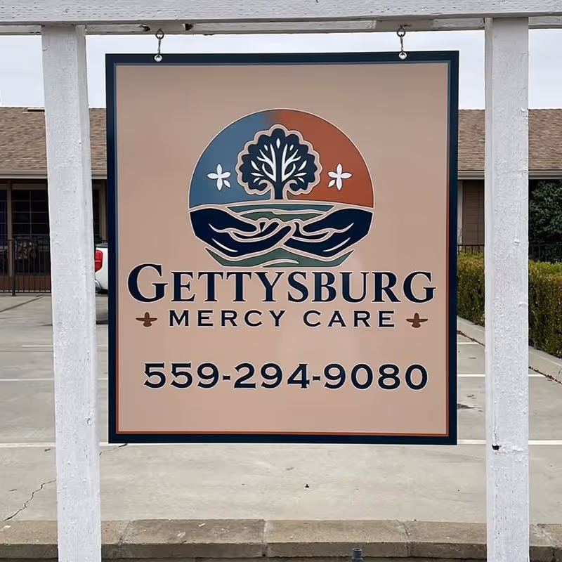 Outdoor sign shows Gettysburg Mercy Care logo and contact number.