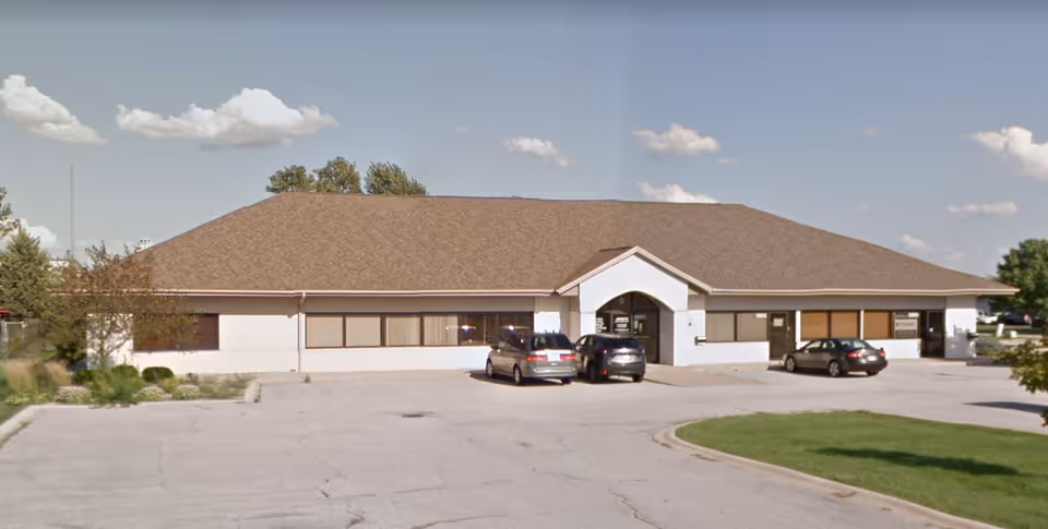 A single-story Allpoints Home Health Care facility with a brown roof and parked cars.